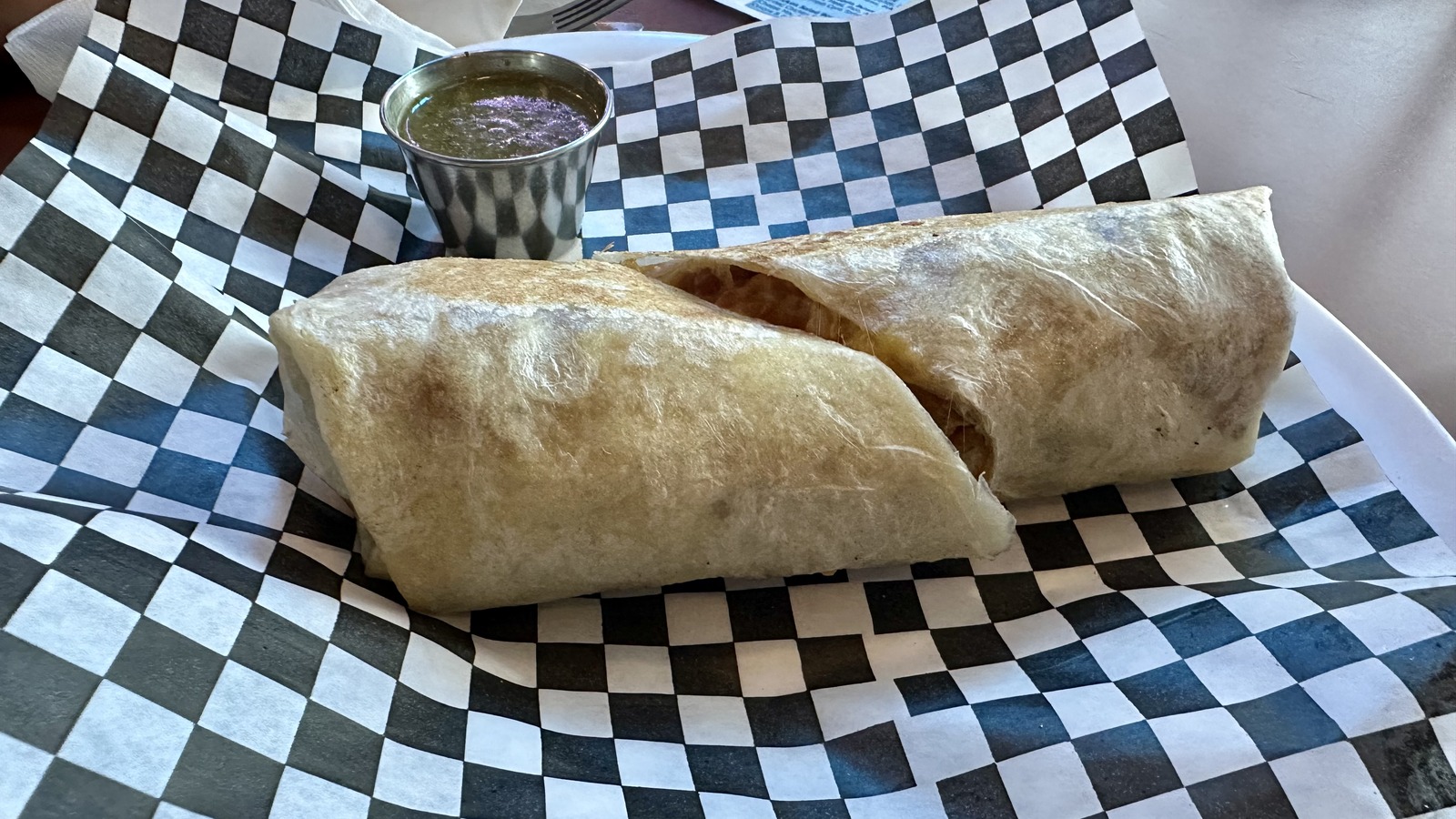 Large breakfast burritos on a checkered basket liner at Diner 50