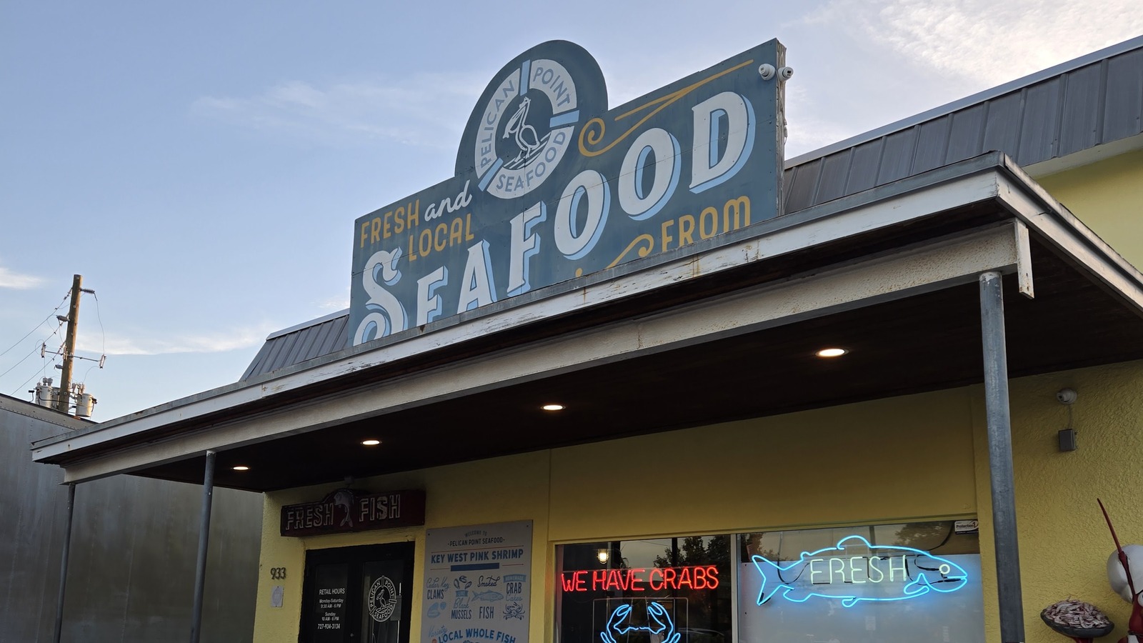 Pelican Point Seafood sign above the market storefront next to Rusty Bellies