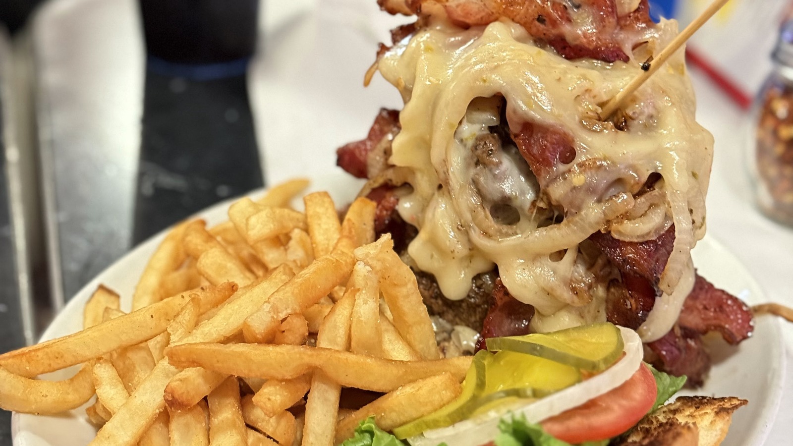 Stacked bacon cheeseburger and fries at Little Anthony's Diner