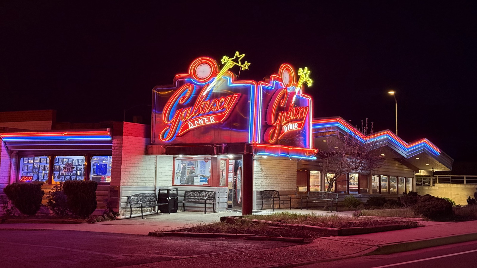 Galaxy Diner lit up in red and blue neon on Route 66 after dark