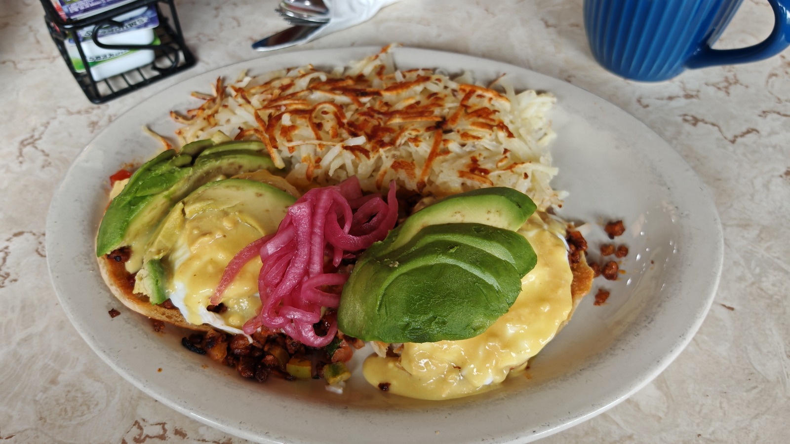 Avocado-topped breakfast plate with hashbrowns at Galaxy Diner
