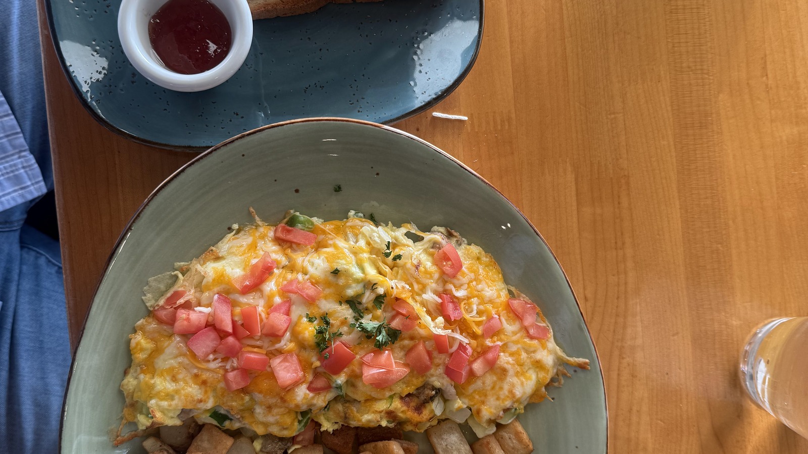 Overhead breakfast plate with omelet, toast, and home fries at T.C. Eggington's