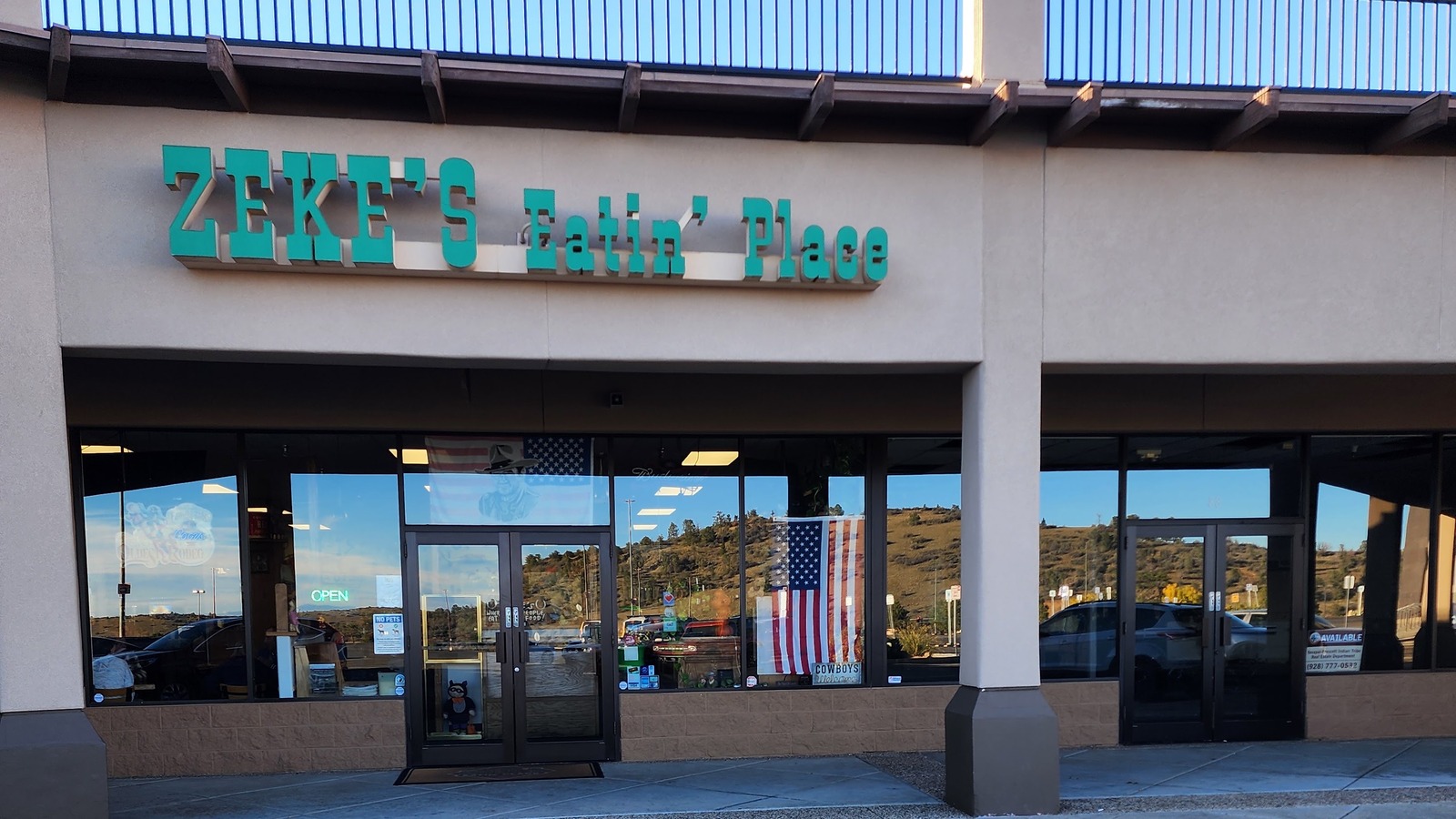 Daylight storefront and hillside reflections at Zeke's Eatin' Place in Prescott