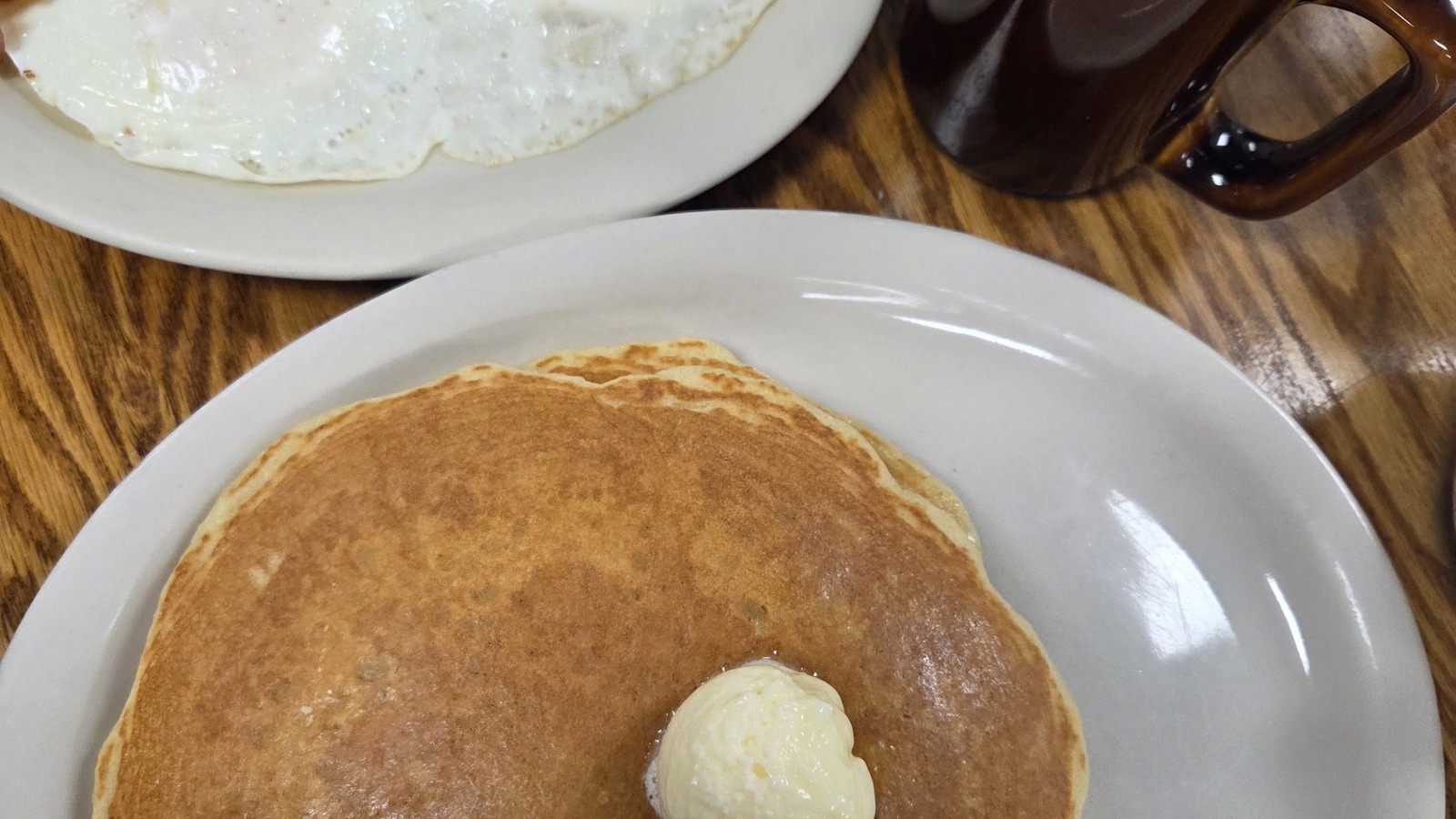 Large pancake with bacon, eggs, and coffee at Zeke's Eatin' Place