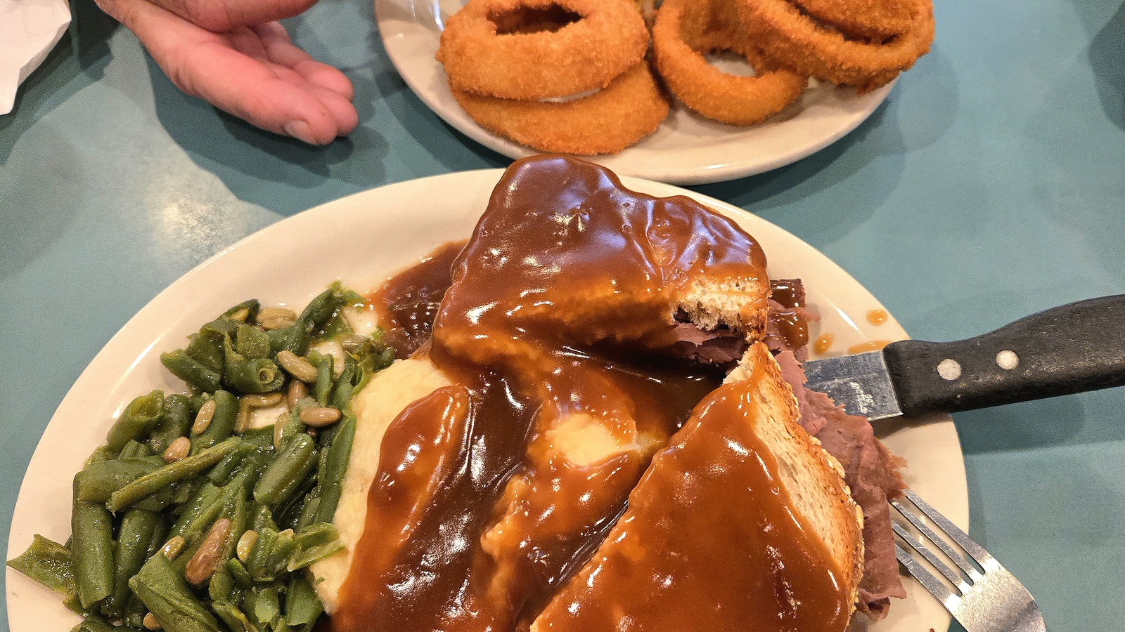 Comfort-food plate with gravy, green beans, and onion rings at Randy's Restaurant & Ice Cream