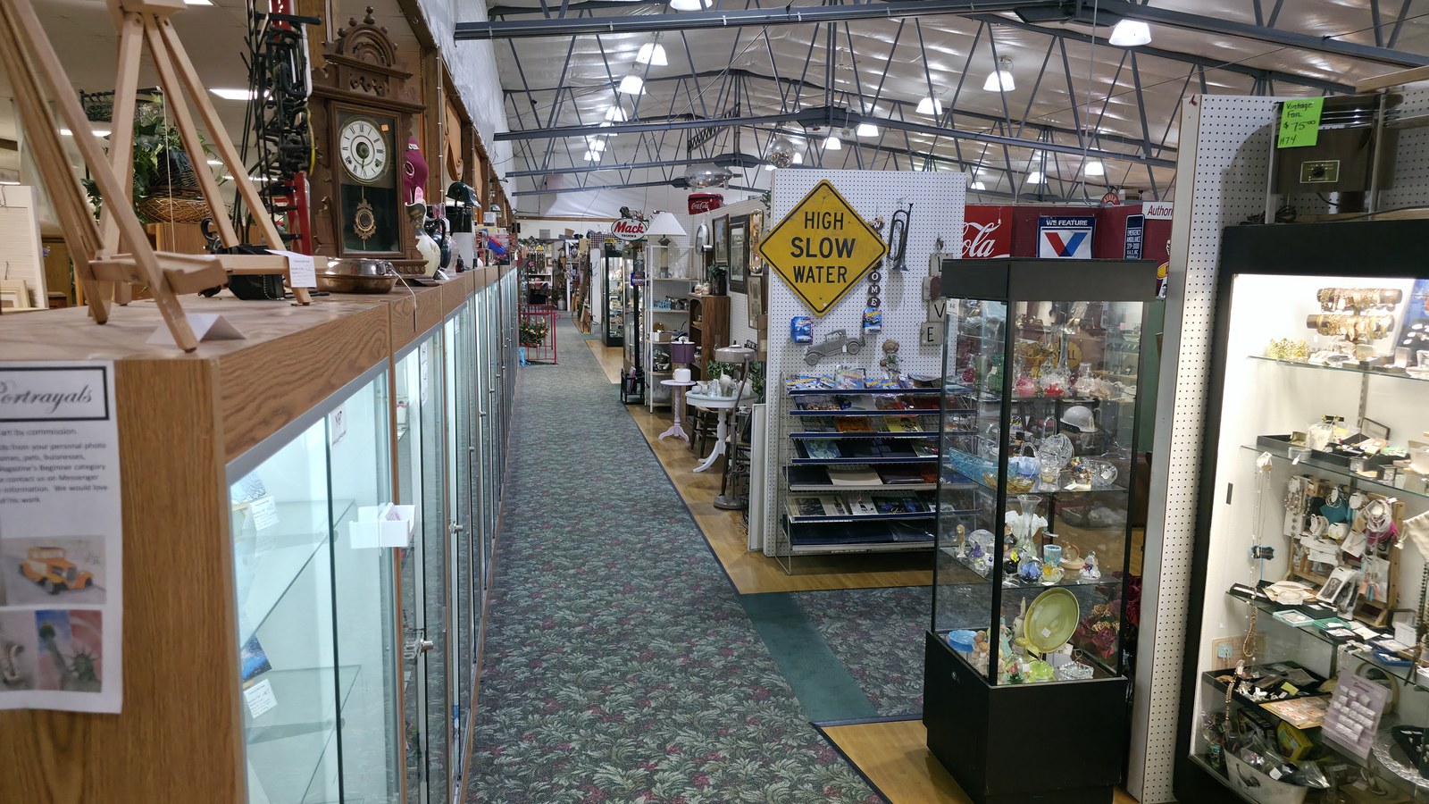 Long carpeted aisle and glass cases inside Treasure Mart Antique Mall in Kokomo
