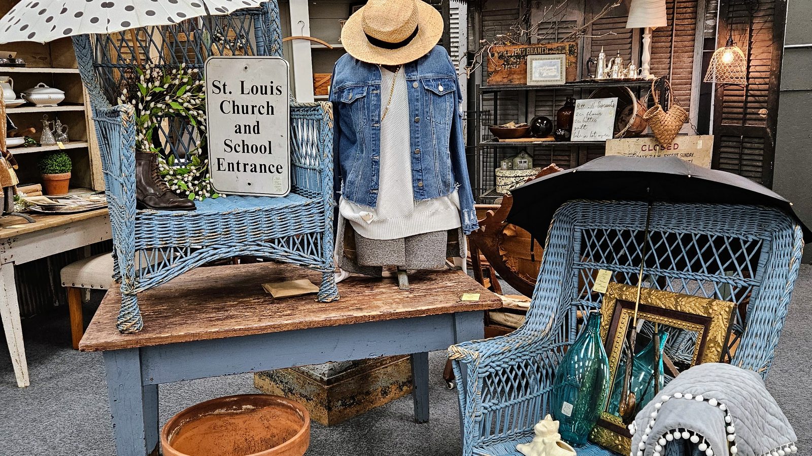 Blue wicker chairs and cottage-style vignette inside Ohio Valley Antique Mall
