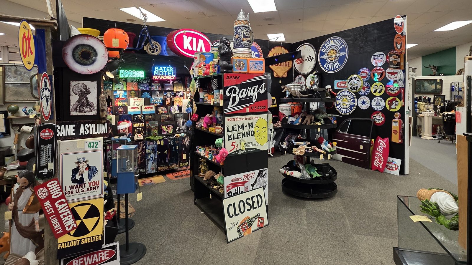 Pop-culture signs and vintage aisle inside Ohio Valley Antique Mall