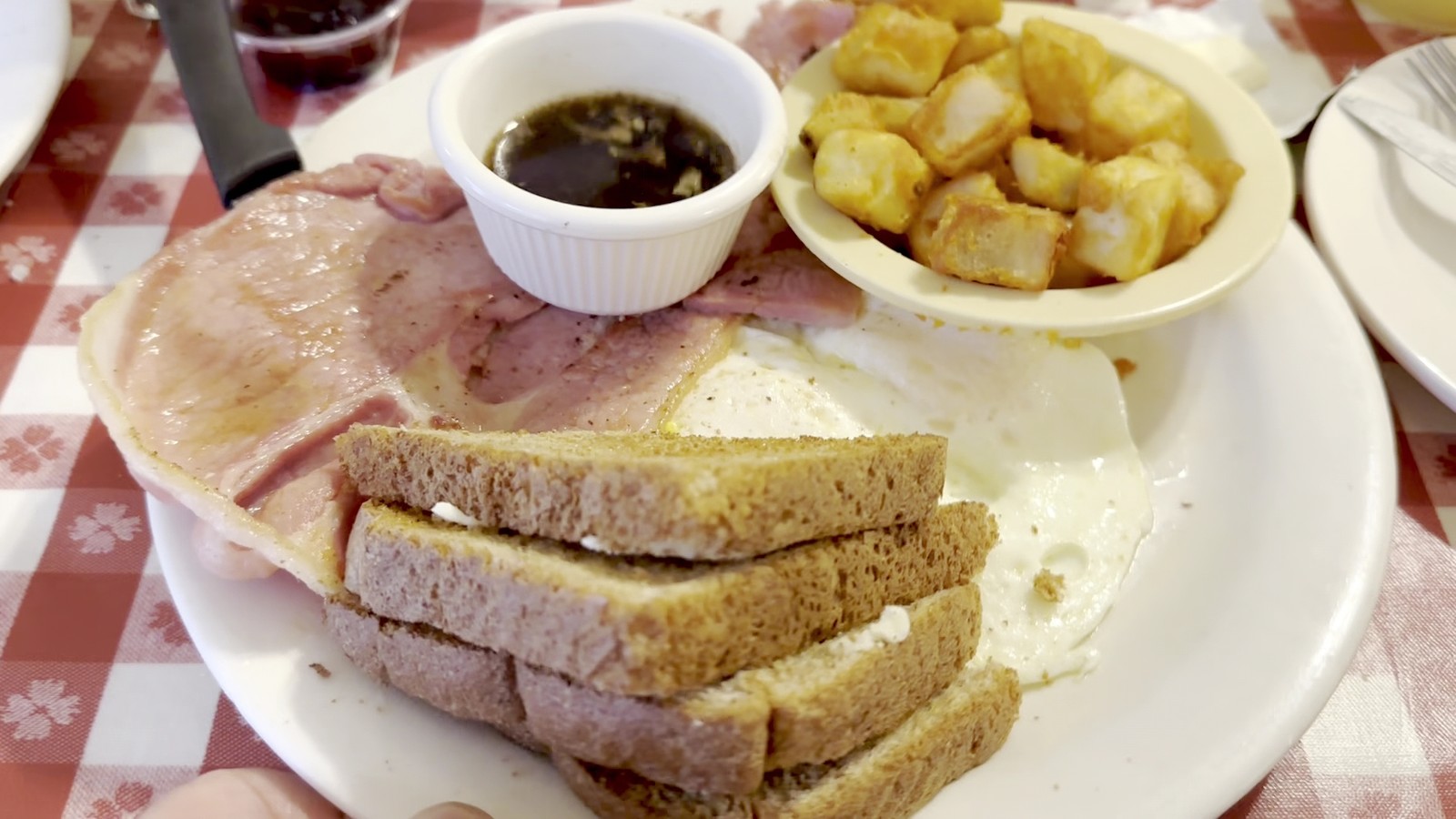 Country ham breakfast with eggs, toast, potatoes, and red-eye gravy at The Loveless Cafe