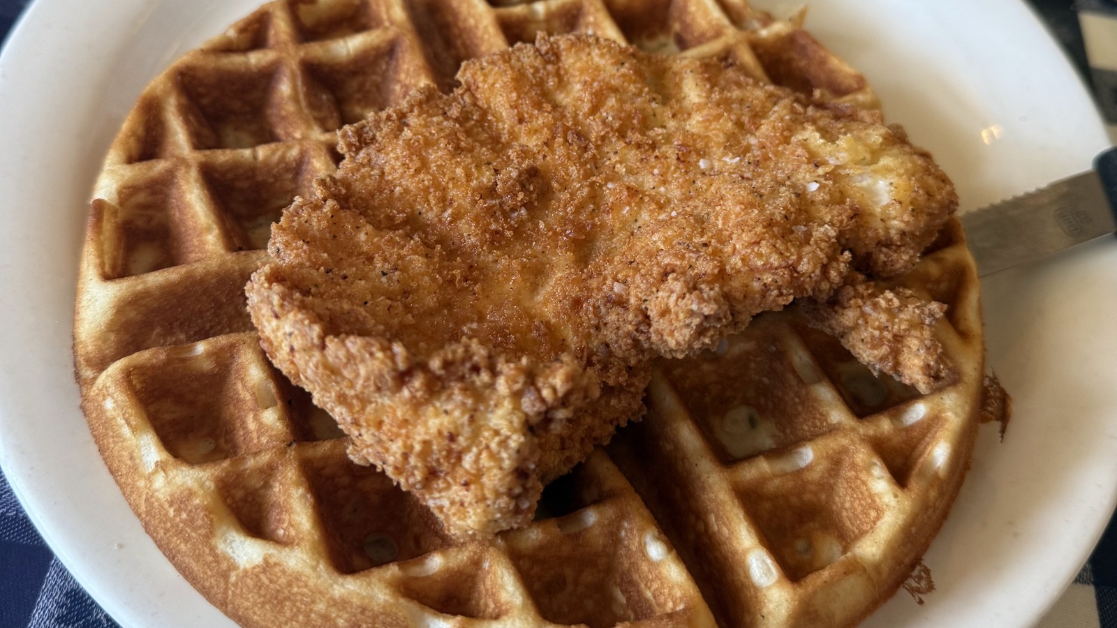 Crisp chicken laid over a waffle with syrup and biscuits at The Loveless Cafe