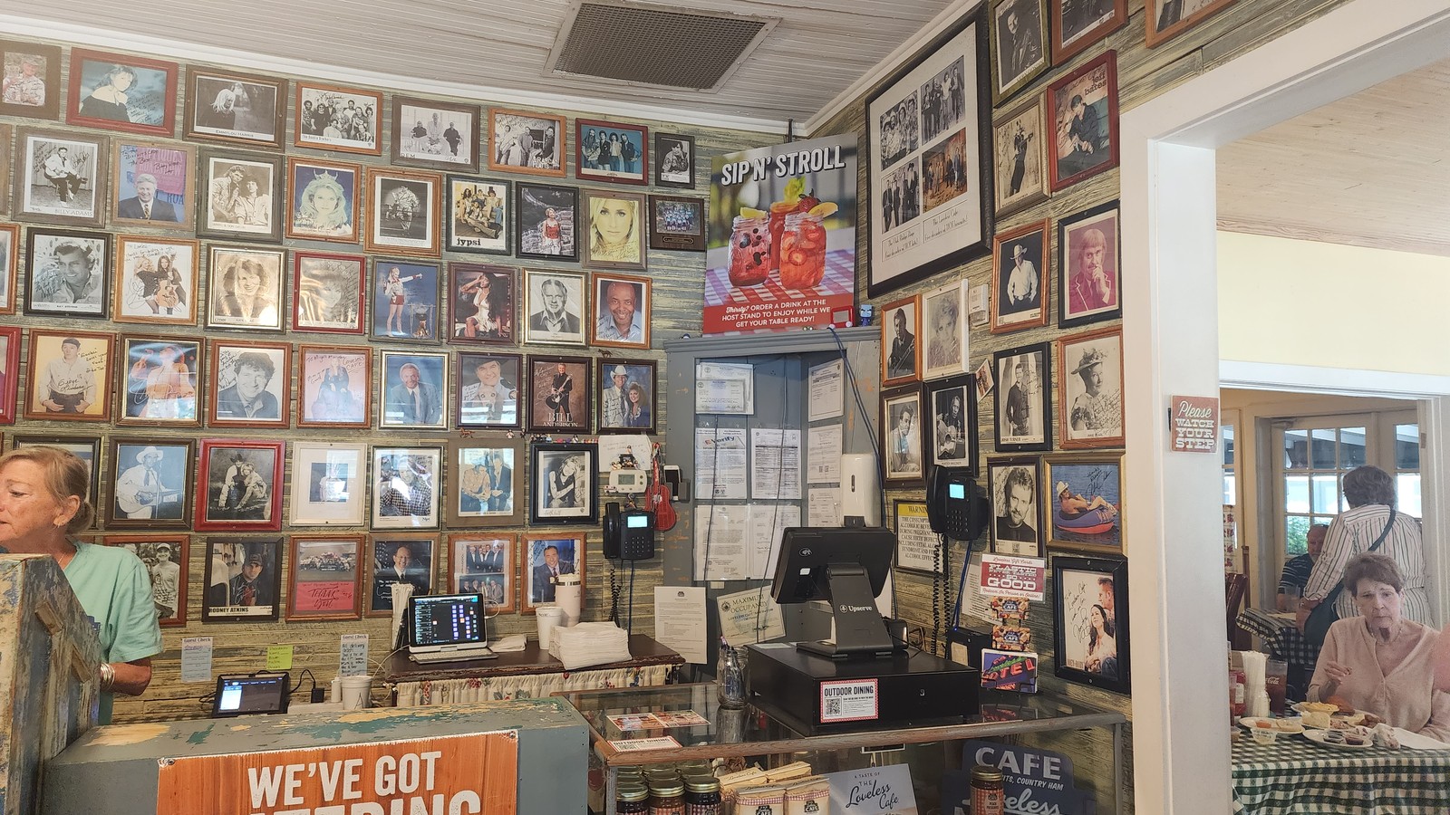 Wall of signed celebrity photos near the host stand at The Loveless Cafe