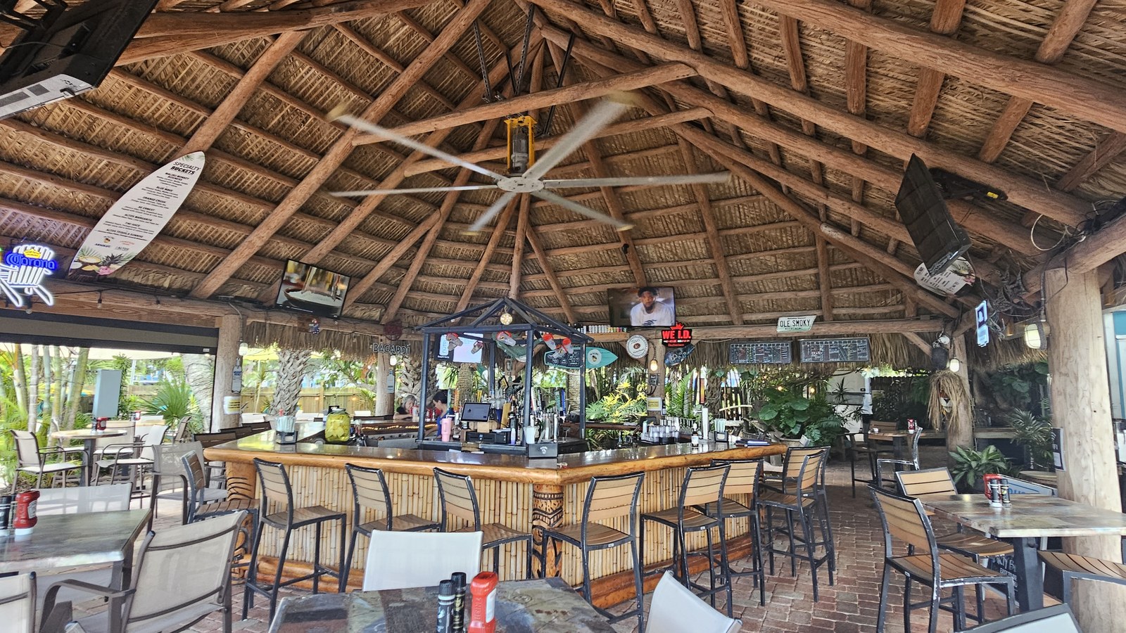 The outback tiki bar with thatched roof and open seating at The Shack in Palm Bay