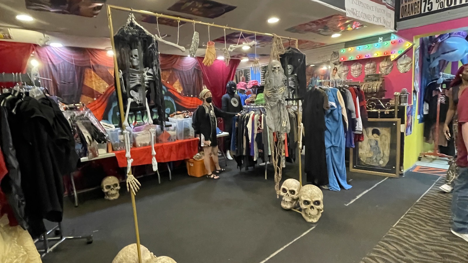 Vintage clothing and costume-filled room with colorful decor at Philly AIDS Thrift