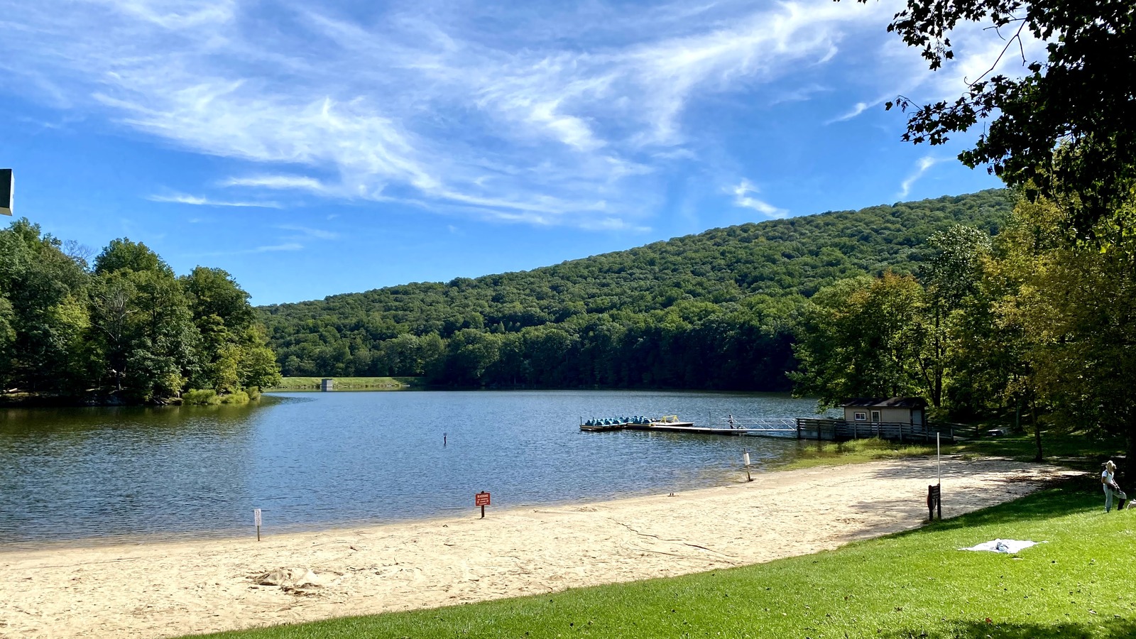 Hunting Creek Lake framed by forested slopes and a sandy shoreline.