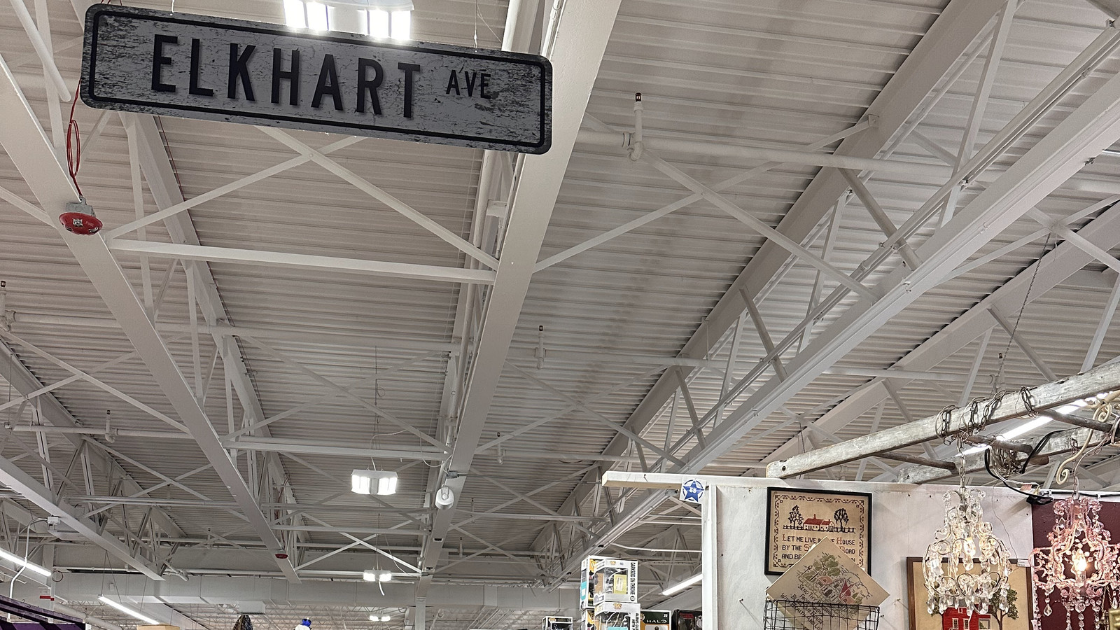 Aisle beneath an Elkhart Avenue sign inside America's Antique Mall in Highland