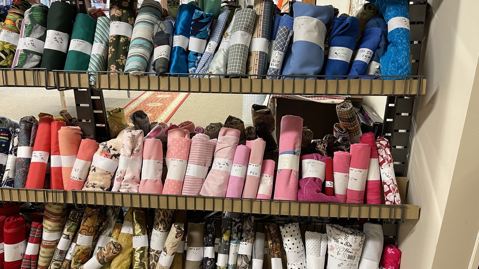 Rolled fabric in florals, plaids, and bright solids at Lancaster Creative Reuse in Lancaster.