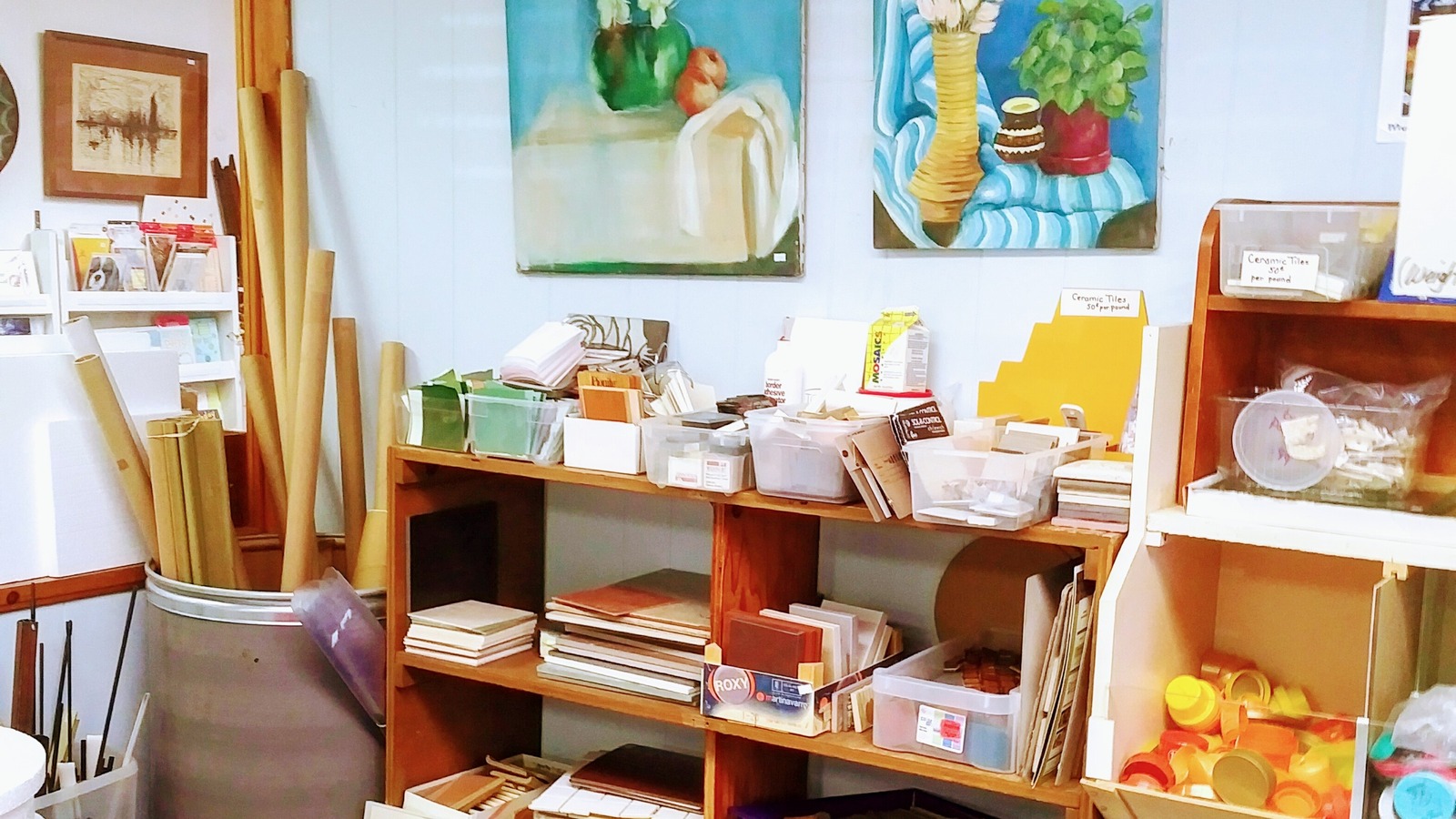 Paintings, tile pieces, cardboard tubes, and mixed supplies at Lancaster Creative Reuse.