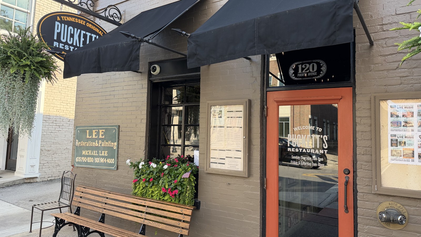 Puckett's Tennessee Original sign, orange front door, and entry bench in Franklin