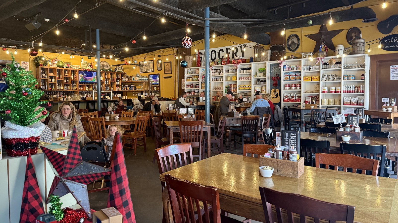 Warm dining room with pantry shelves and grocery-style details inside Puckett's Restaurant