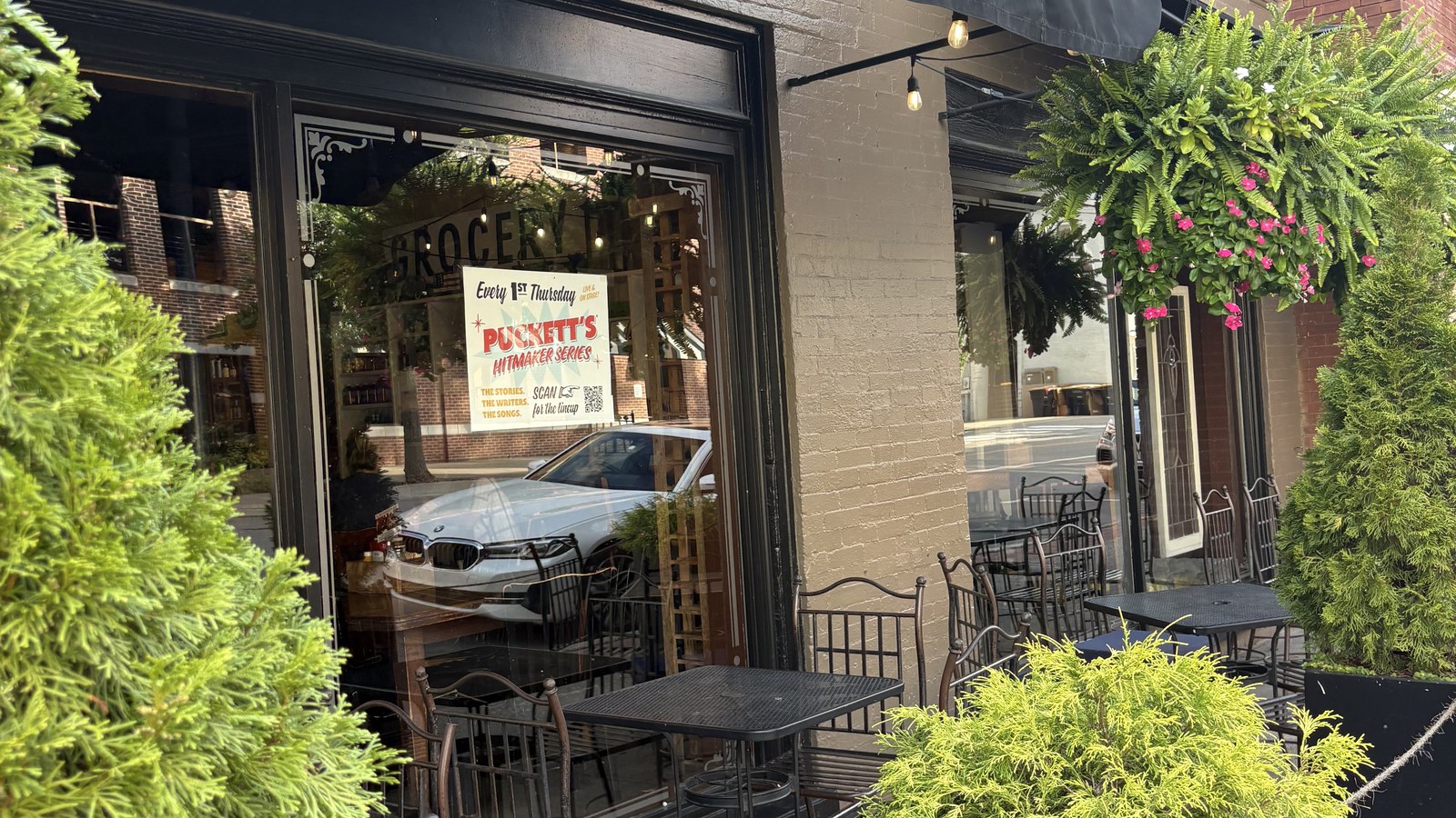 Patio tables and Hitmaker Series poster outside Puckett's Restaurant in downtown Franklin
