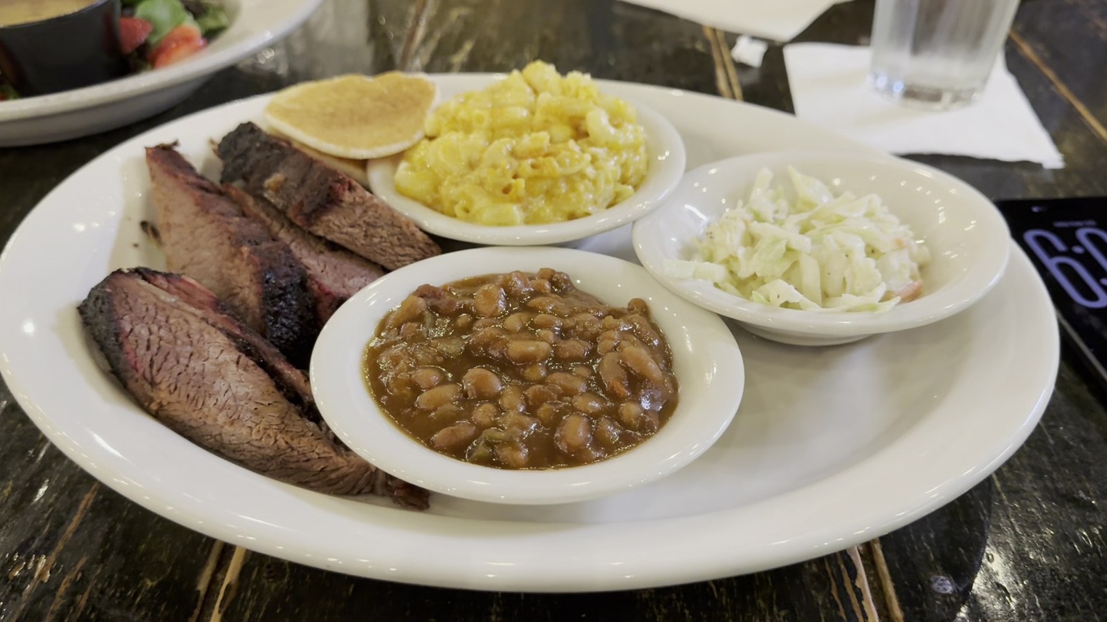 Smoked brisket platter with mac and cheese, beans, slaw, and cornbread at Puckett's Restaurant