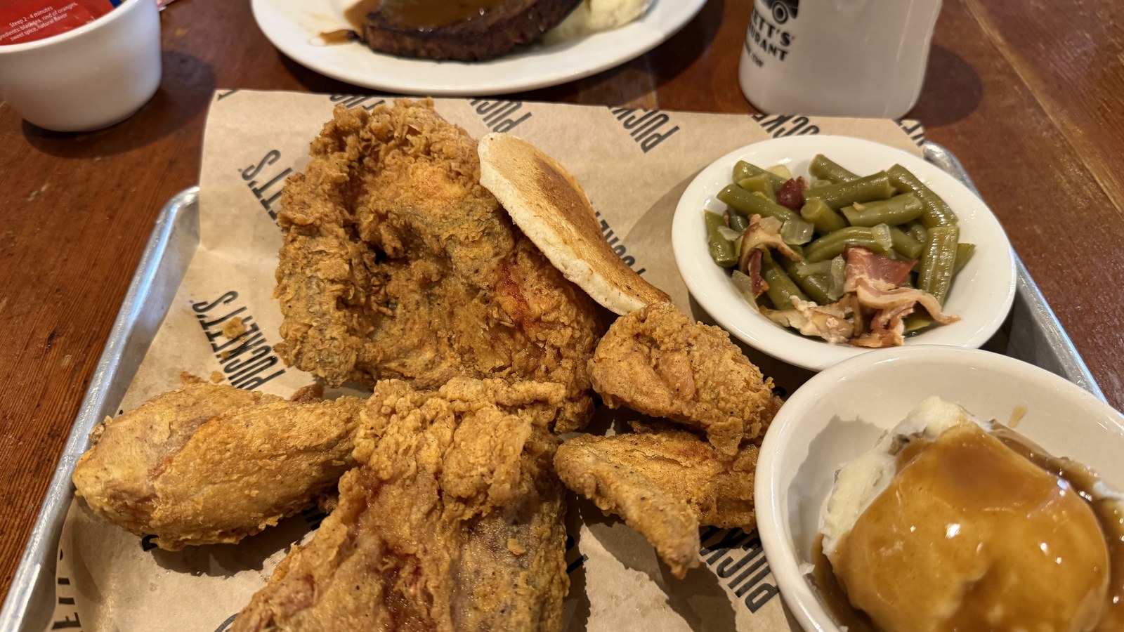 Fried chicken with mashed potatoes, gravy, green beans, and biscuits at Puckett's Restaurant