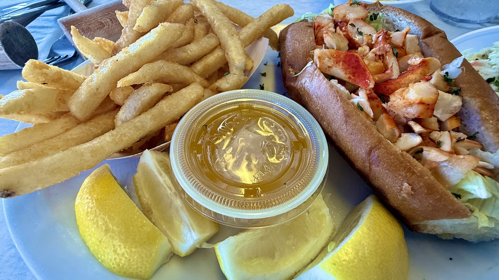 Warm lobster roll with fries and drawn butter at Rustic Inn Crabhouse