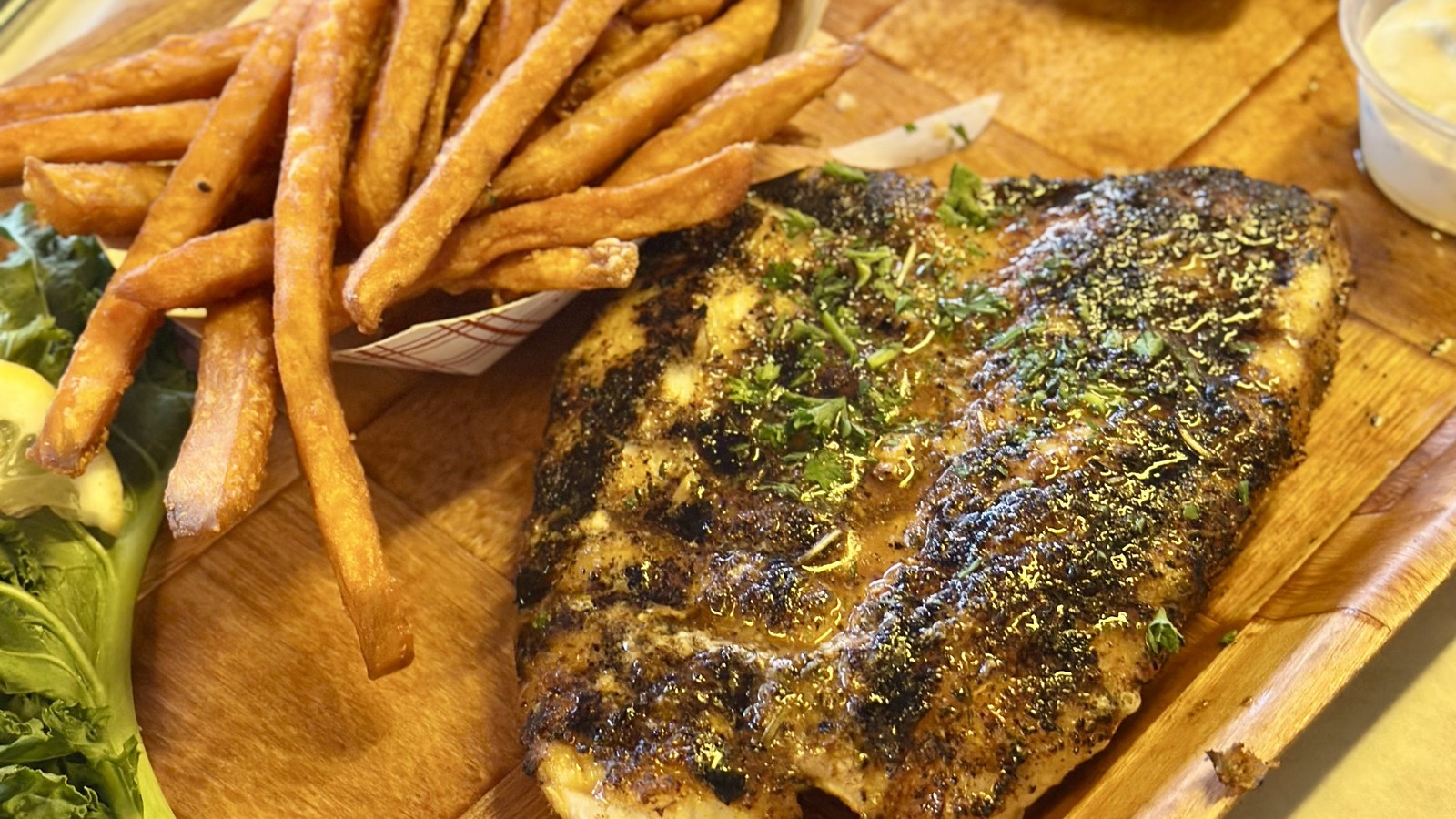 Blackened fish fillet with fries at Rustic Inn Crabhouse in Fort Lauderdale