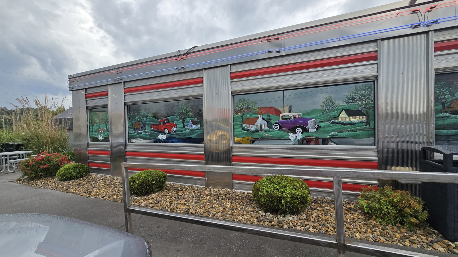 Chrome side wall and painted classic-car mural at Mel's Classic Diner in Pigeon Forge
