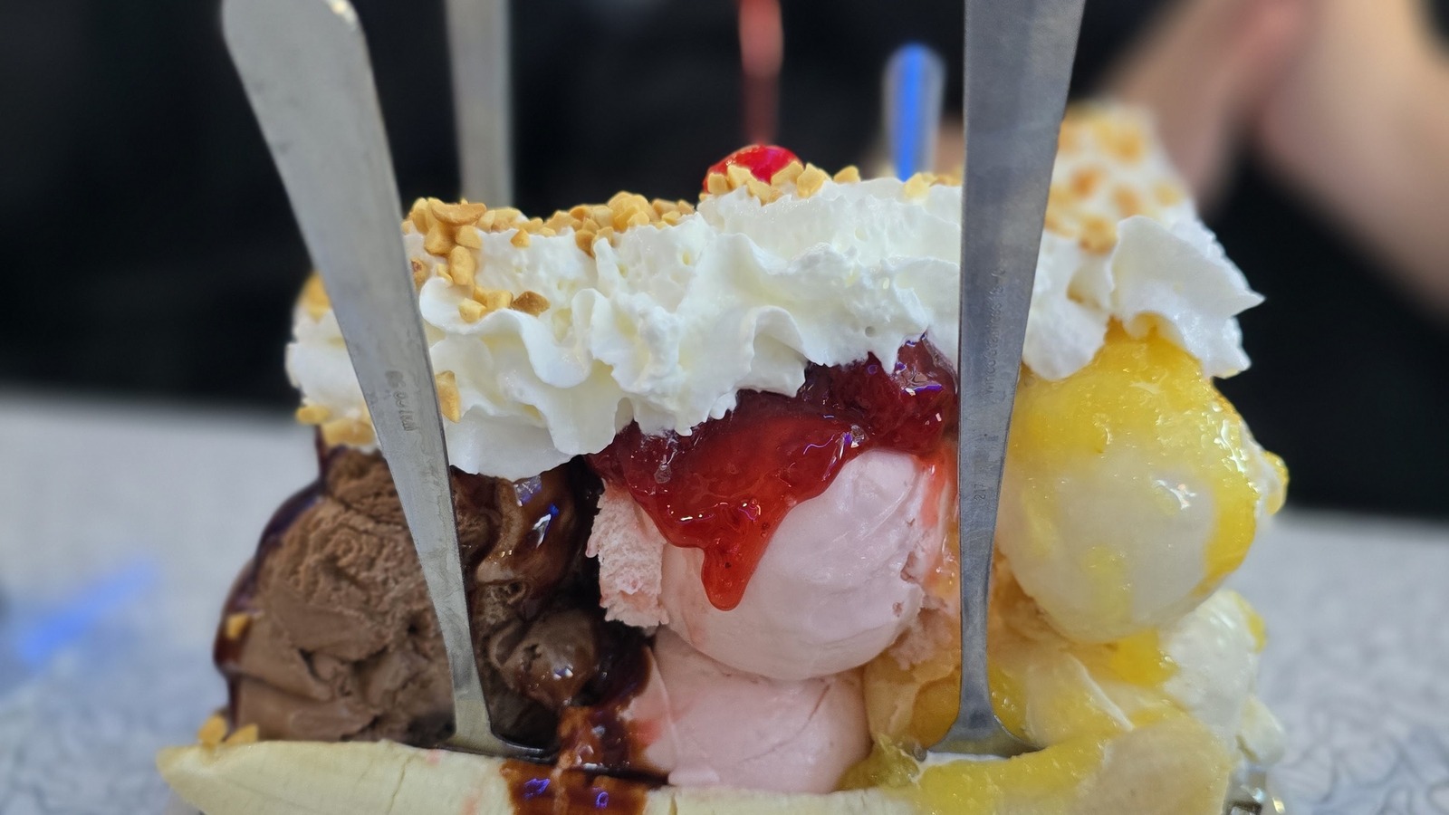 Oversized banana split topped with whipped cream at Mel's Classic Diner