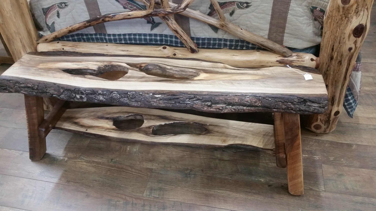 Rustic live-edge wooden bench in front of a log-style bed at Brown County Antique Mall