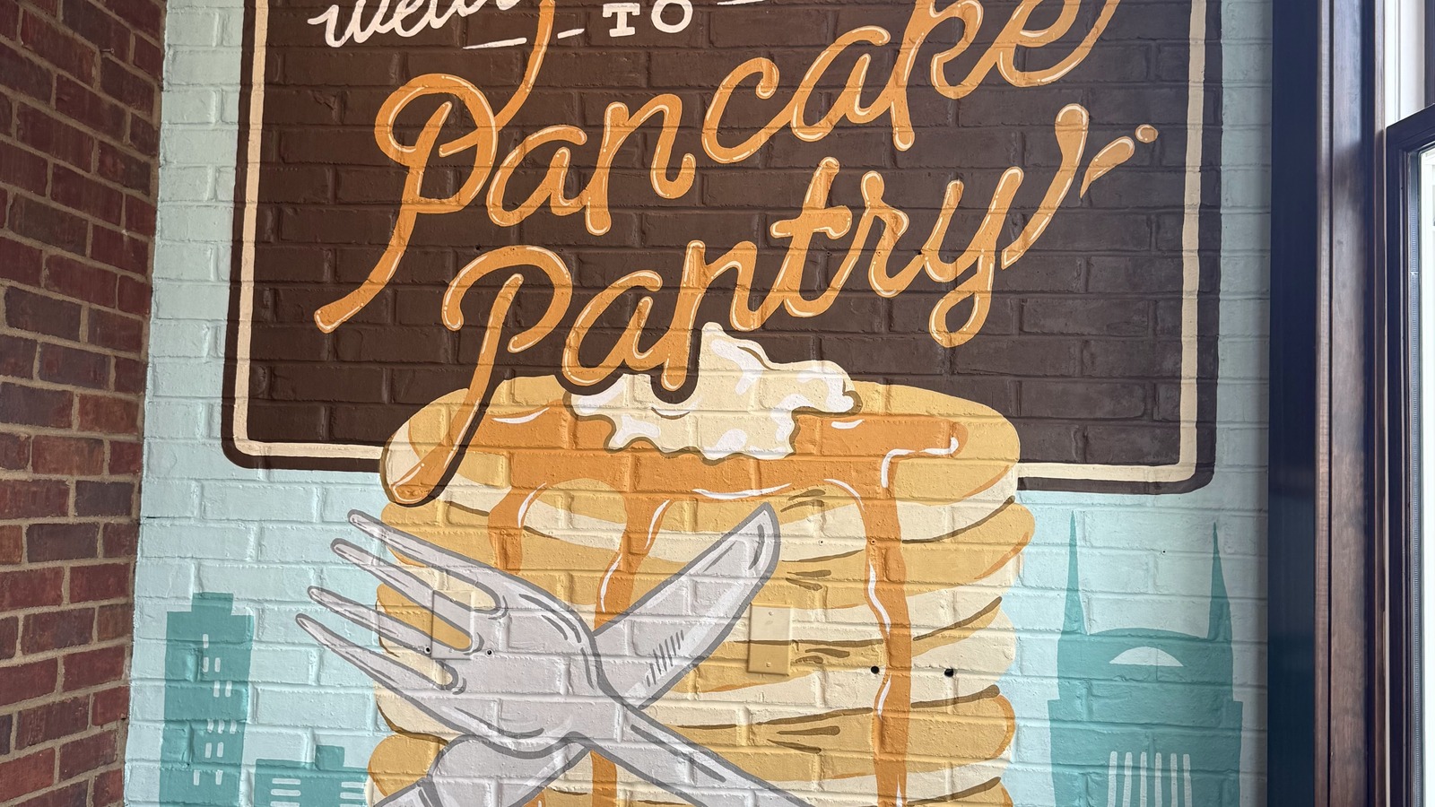 Welcome mural and script Pancake Pantry sign inside the Nashville restaurant