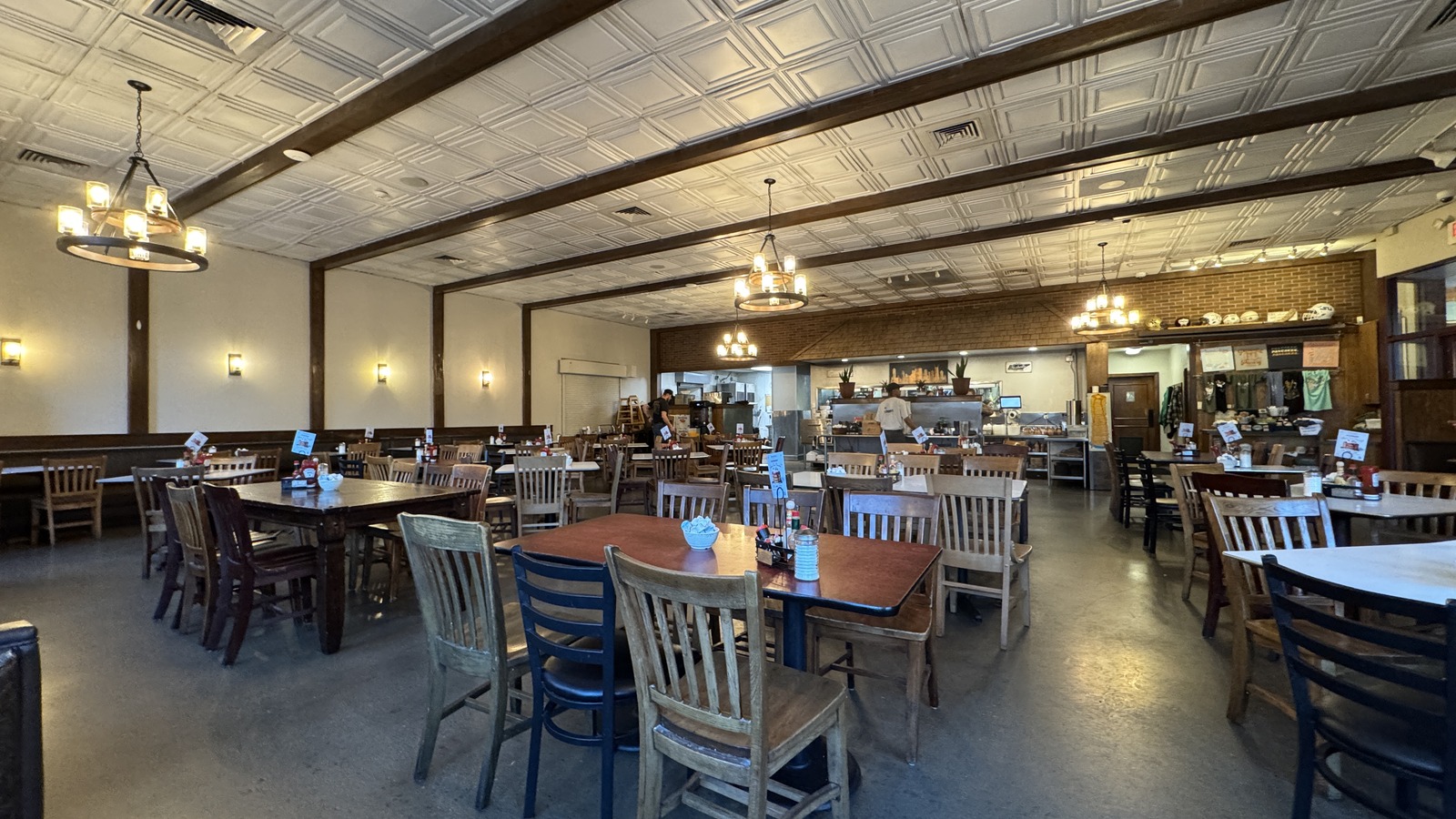 Open dining room with pendant lights and wide tables at The Pancake Pantry