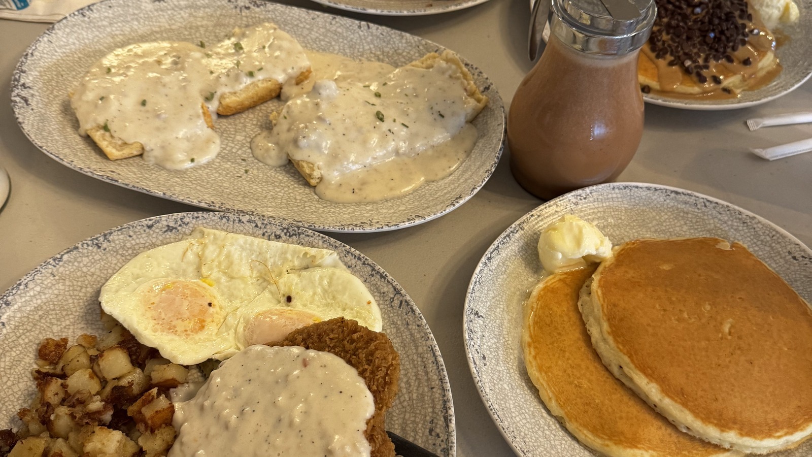 Biscuits with gravy, eggs, and pancakes on a breakfast table at The Pancake Pantry