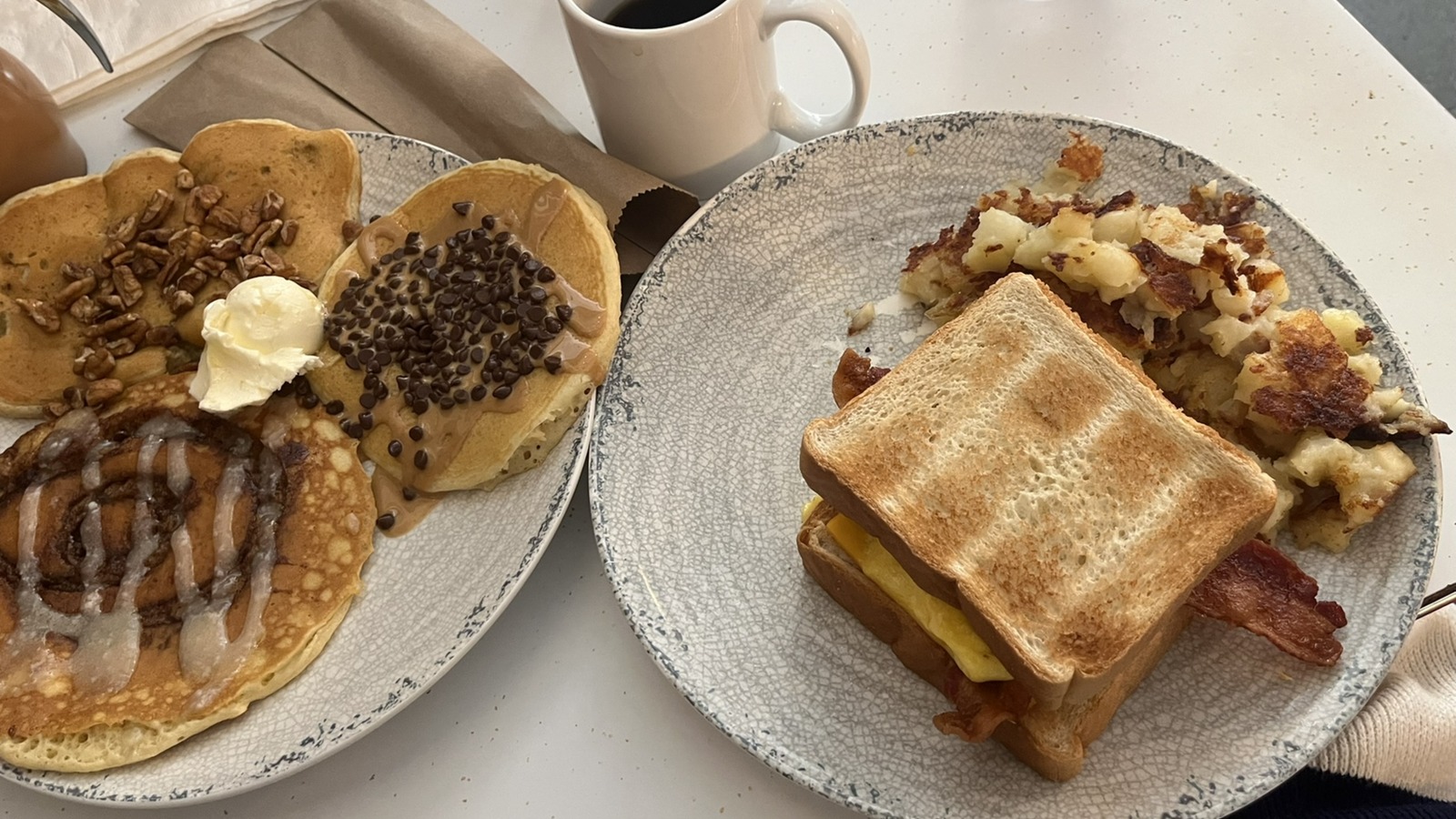 Breakfast sandwich, hashbrowns, and pancake sampler spread at The Pancake Pantry