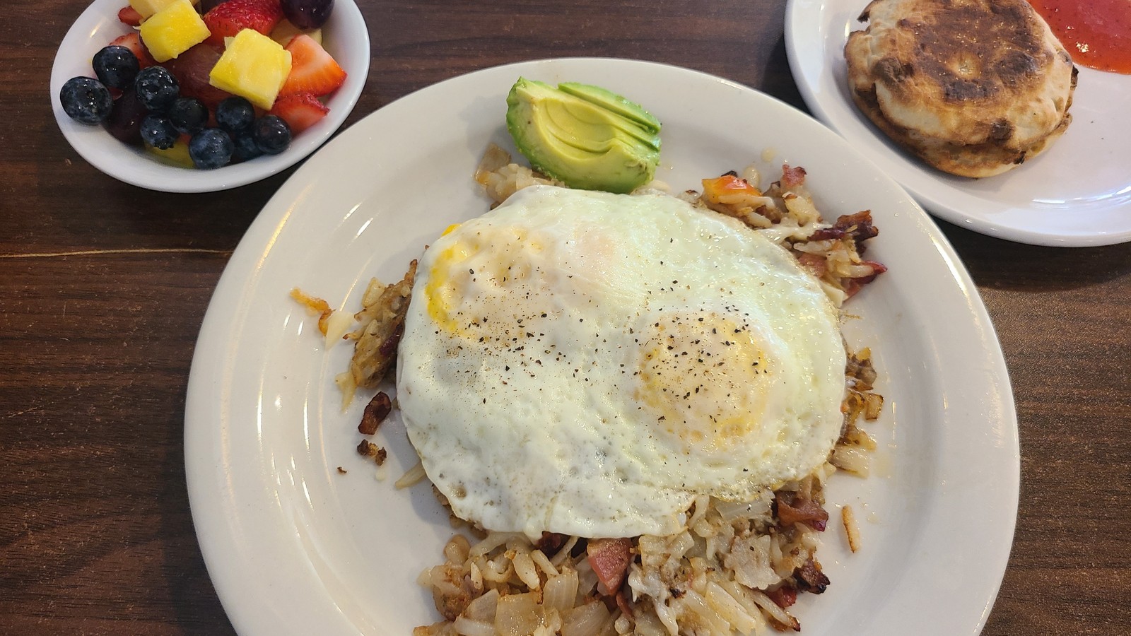 Omelet filled with peppers, onions, sausage, avocado, and fruit at Flat Tire Diner