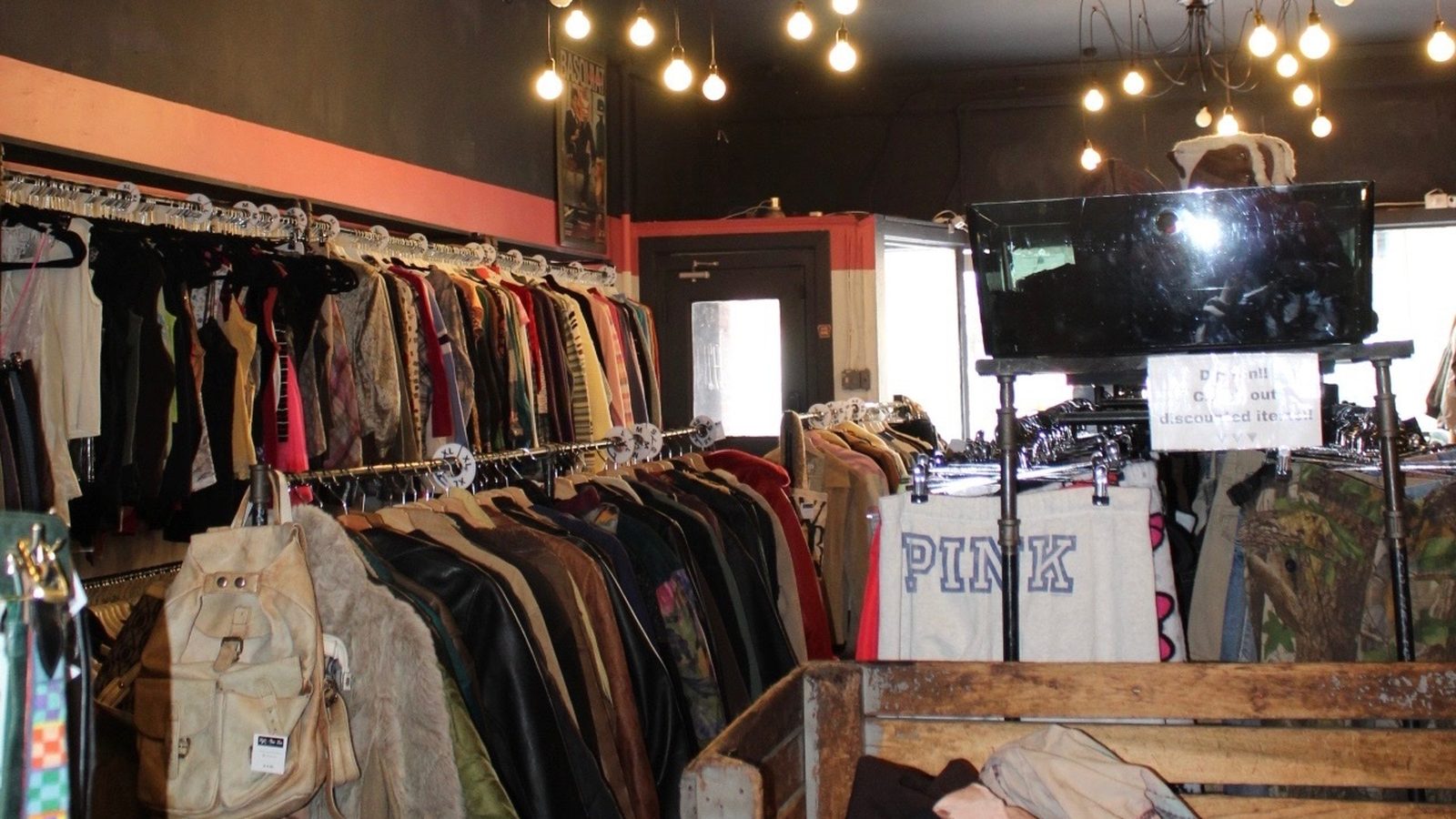 Curated clothing racks and a central display table inside Fifty One Ten Vintage in Pittsburgh.