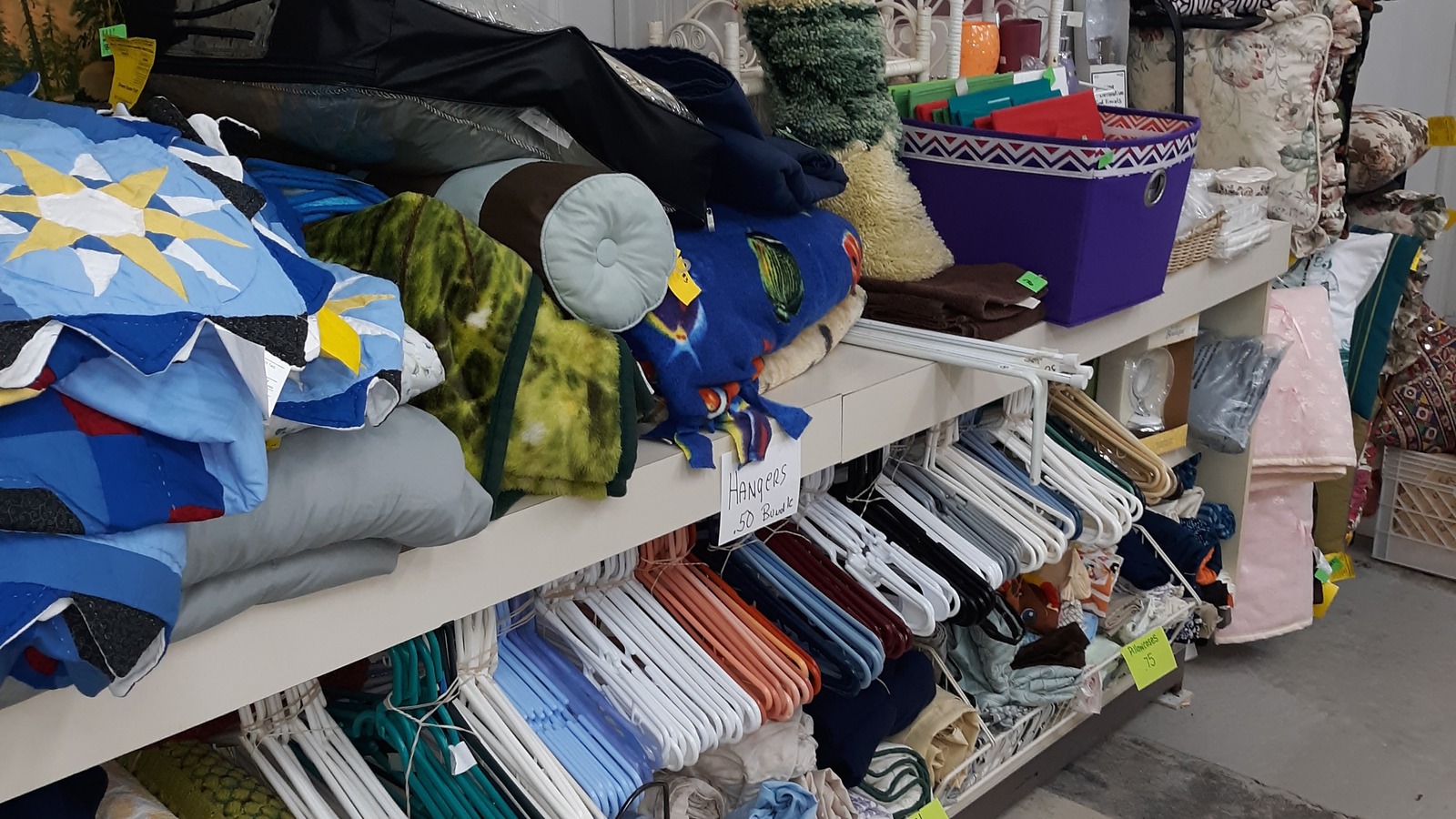 Linens and home-textile shelves inside Green Scene Thrift Store