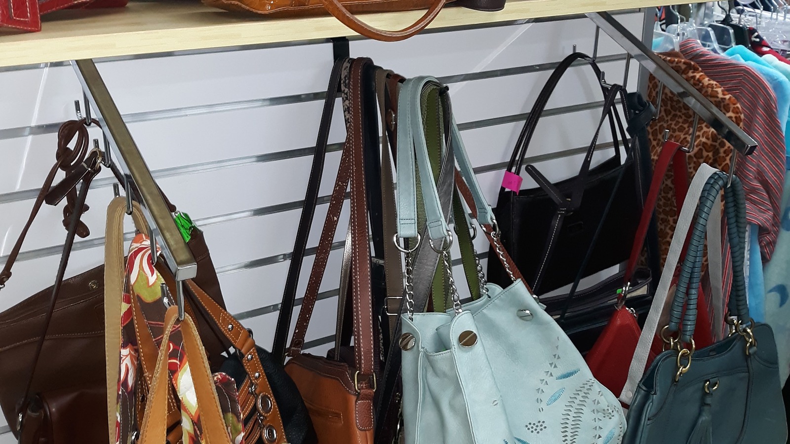 Handbags and accessories wall inside Green Scene Thrift Store