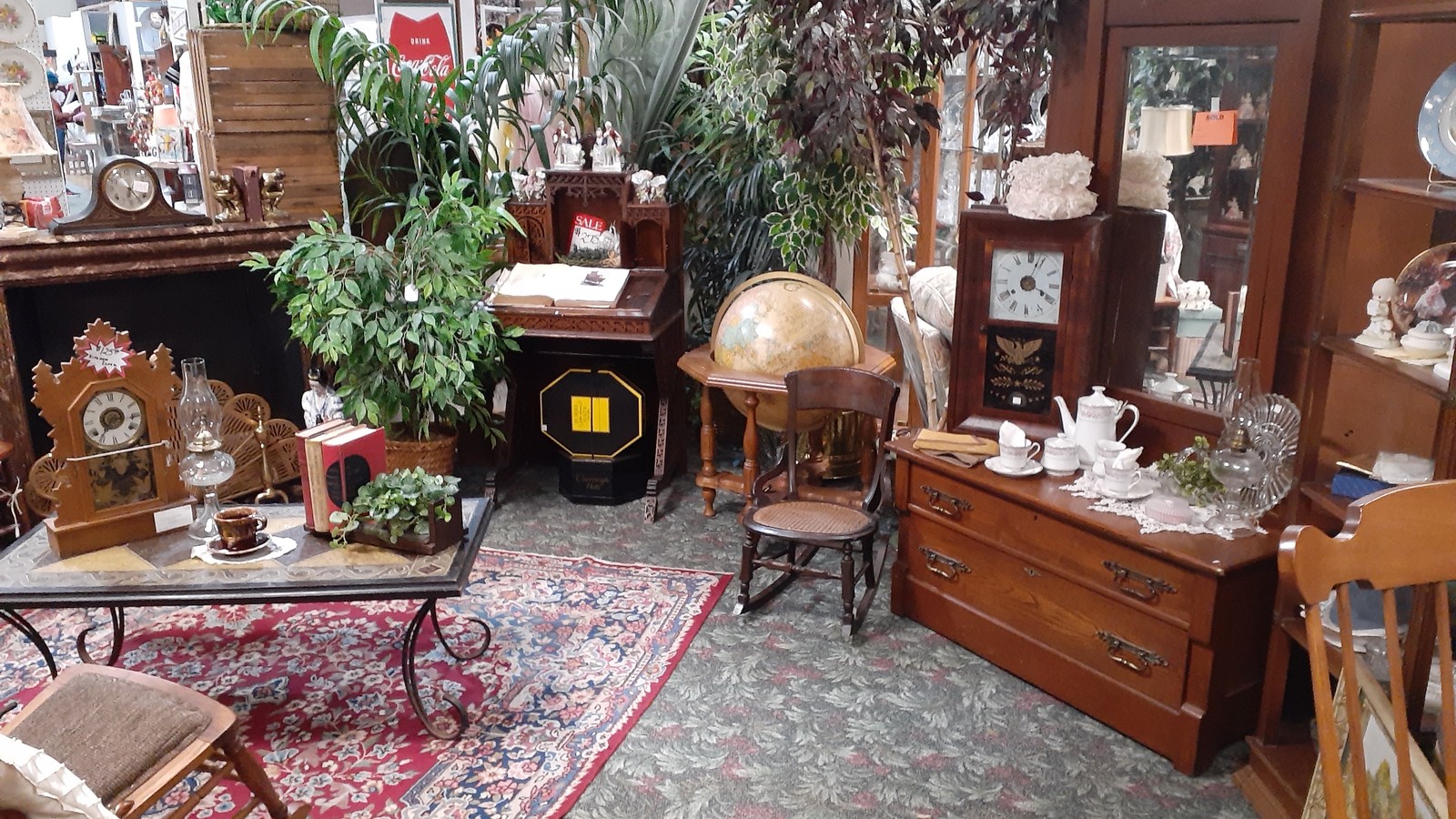 Clock-filled furniture vignette inside Treasure Mart Antique Mall in Kokomo