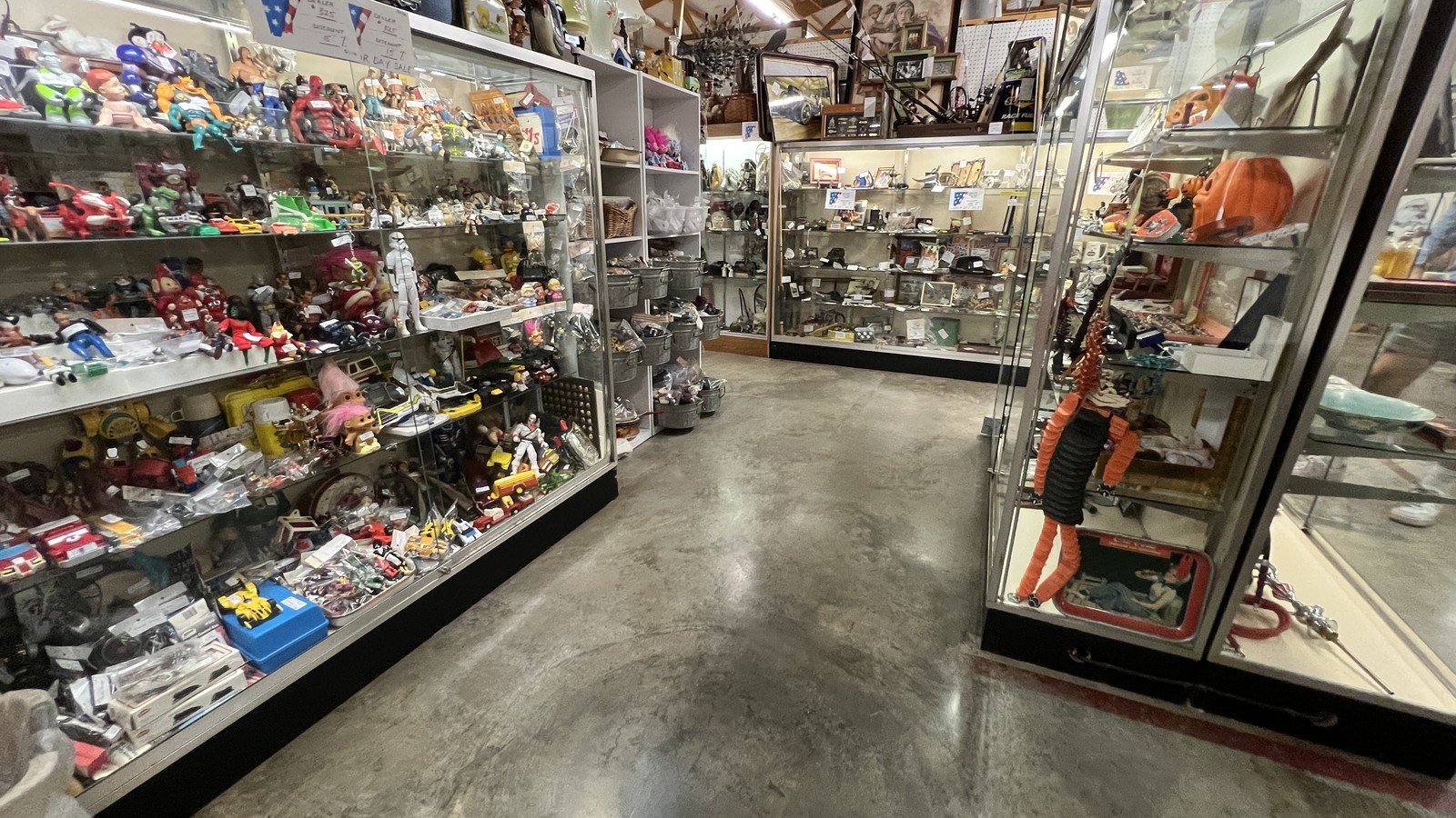 Glassware aisle and polished concrete floor inside Gilley's Antique & Decorator Mall