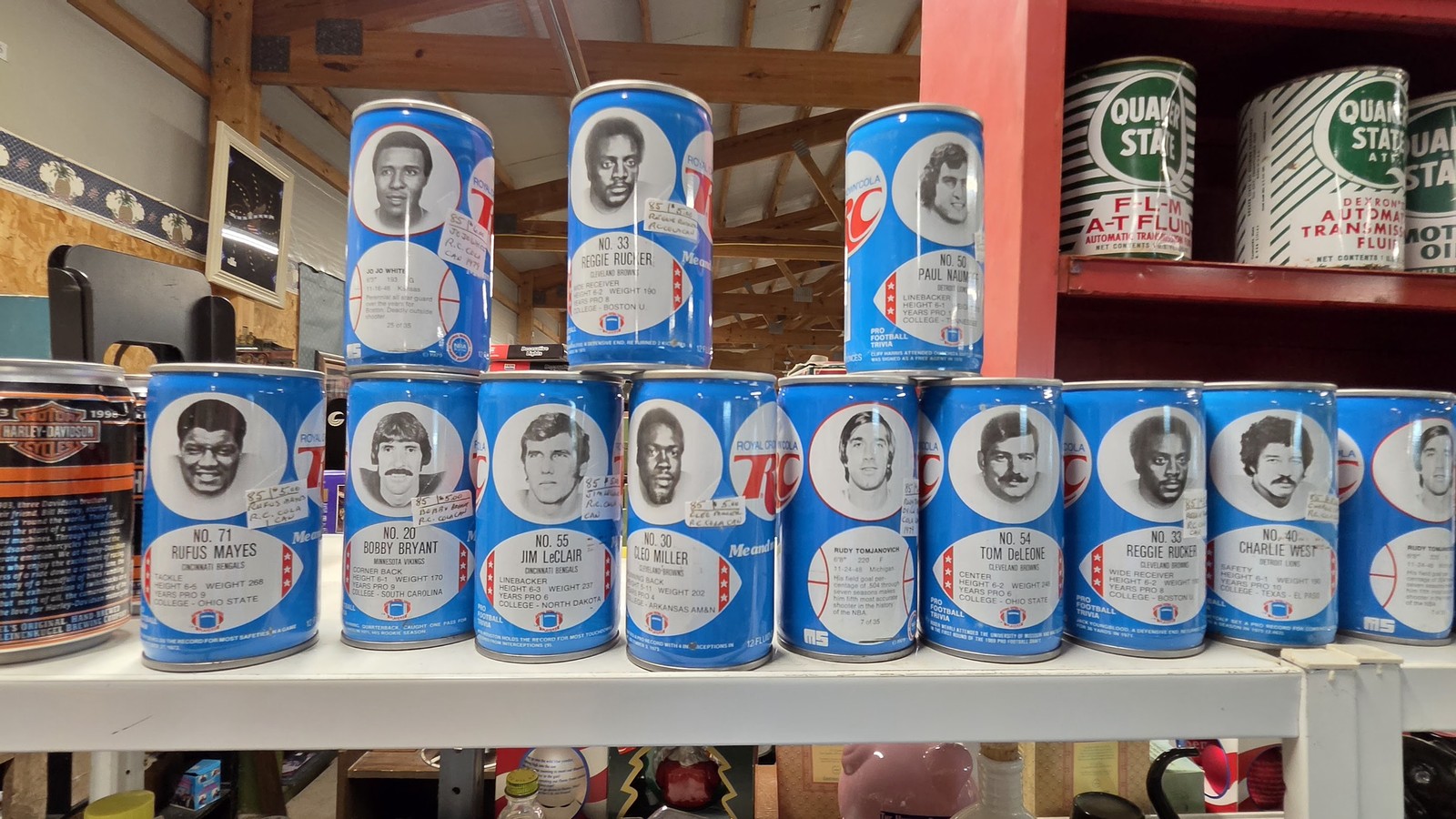 Shelf of collectible cans and vintage tins inside Gilley's Antique & Decorator Mall