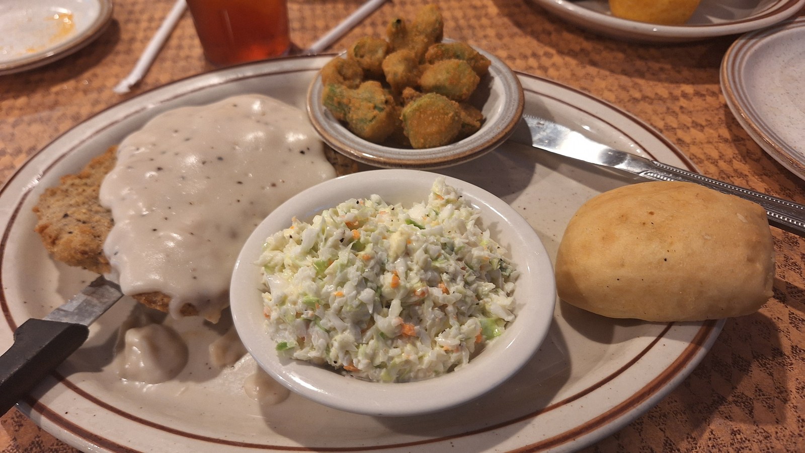 Country fried steak with gravy, fried okra, coleslaw, and roll at Trish's Mountain Diner