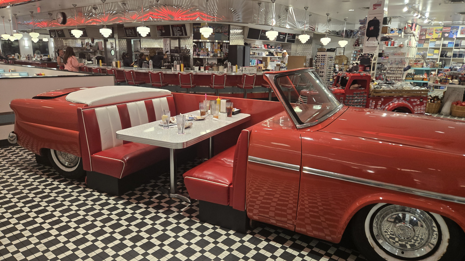 Classic car booth seating beside the counter at Sunliner Diner