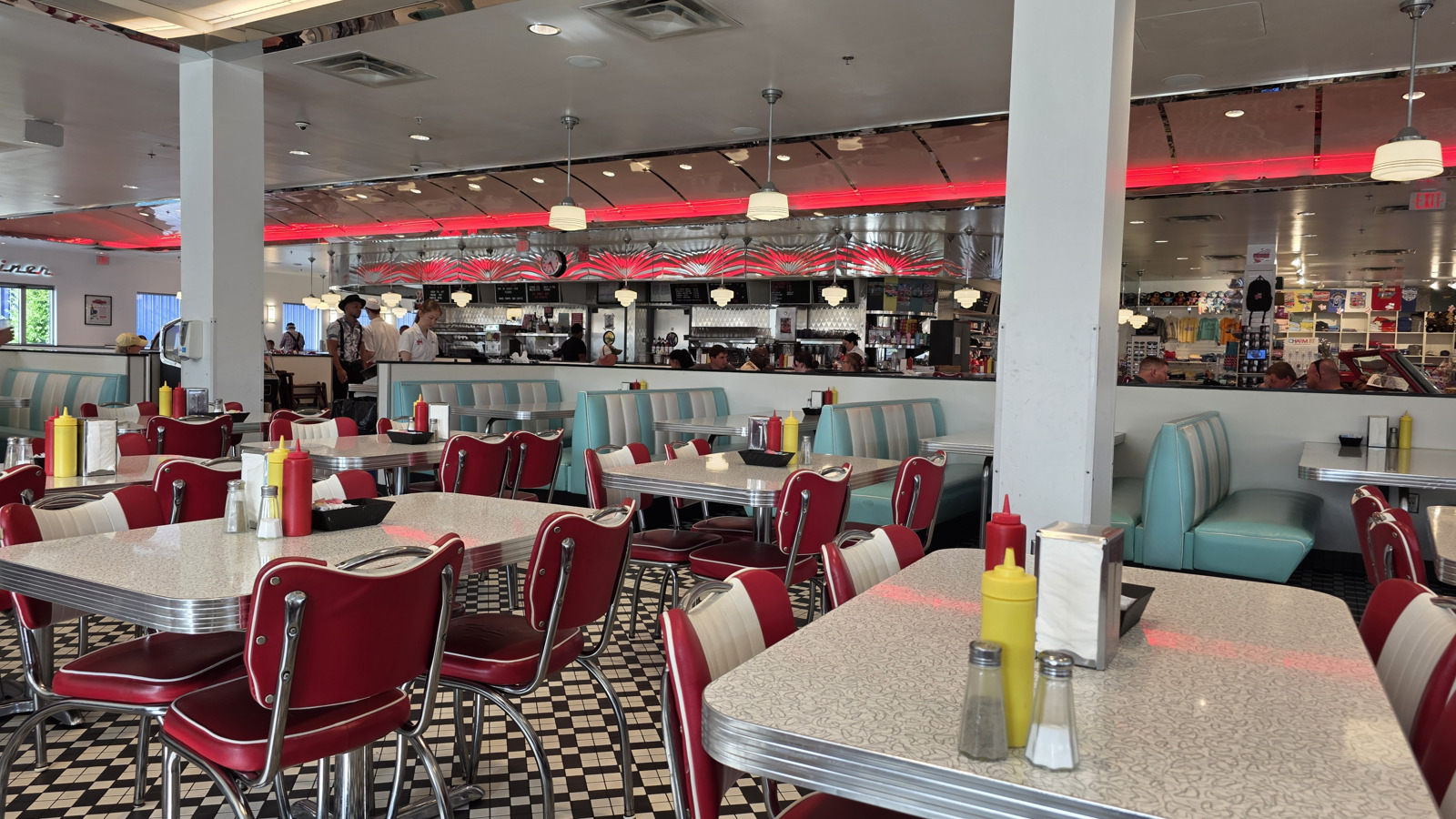 Turquoise booths and checkerboard floor inside Sunliner Diner