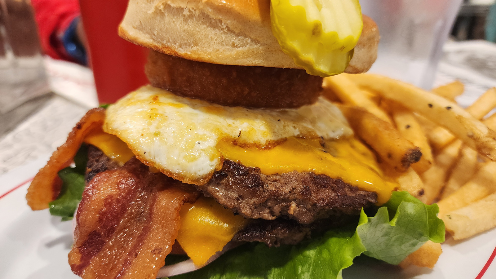 Bacon cheeseburger with a fried egg and fries at Sunliner Diner