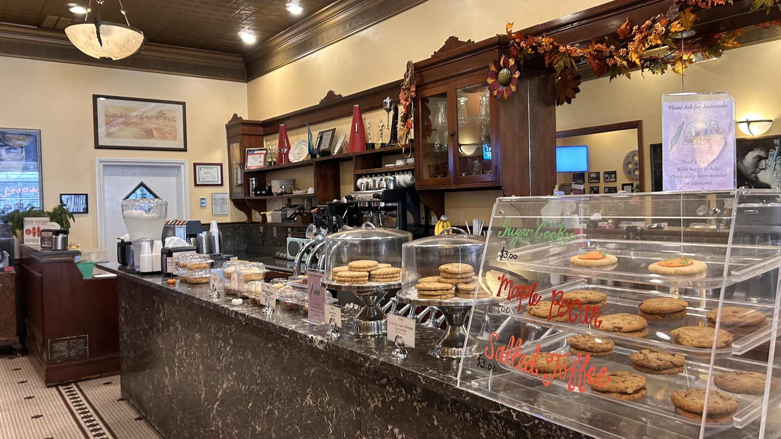Black marble counter, cookie case, and wood back bar inside Leopold's Ice Cream