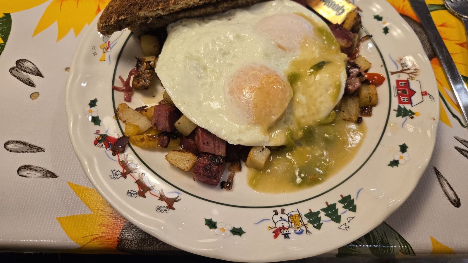 Breakfast plate with eggs, green chile gravy, and hash at Doo-Dah Diner