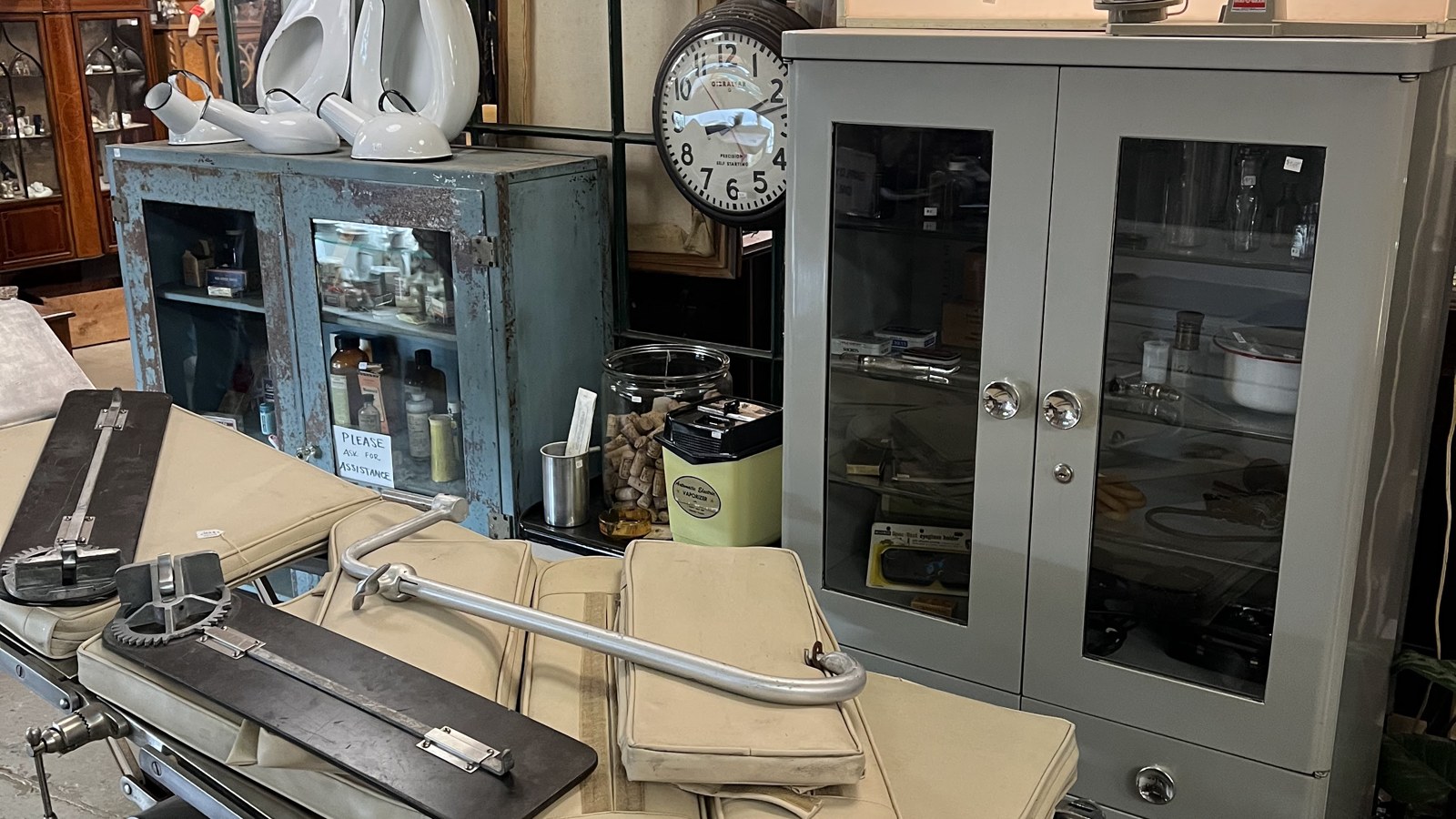 Operating room sign, medical cabinet, clocks, and exam chair inside The Bomb Shelter