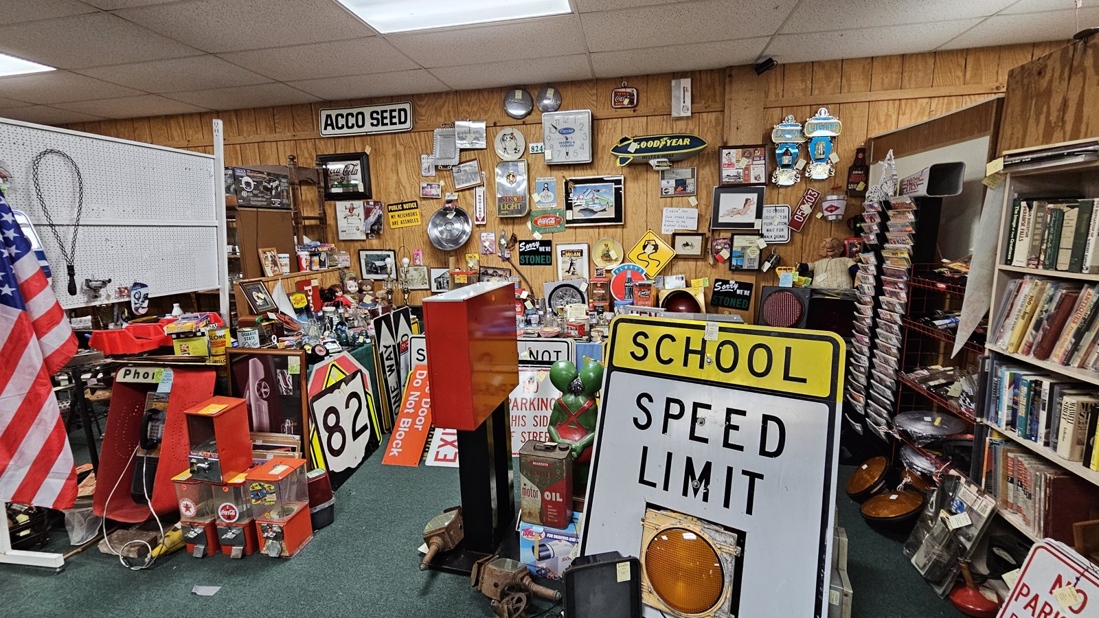 Americana-themed booth with school signs, flags, and vintage collectibles inside I-76 Antique Mall